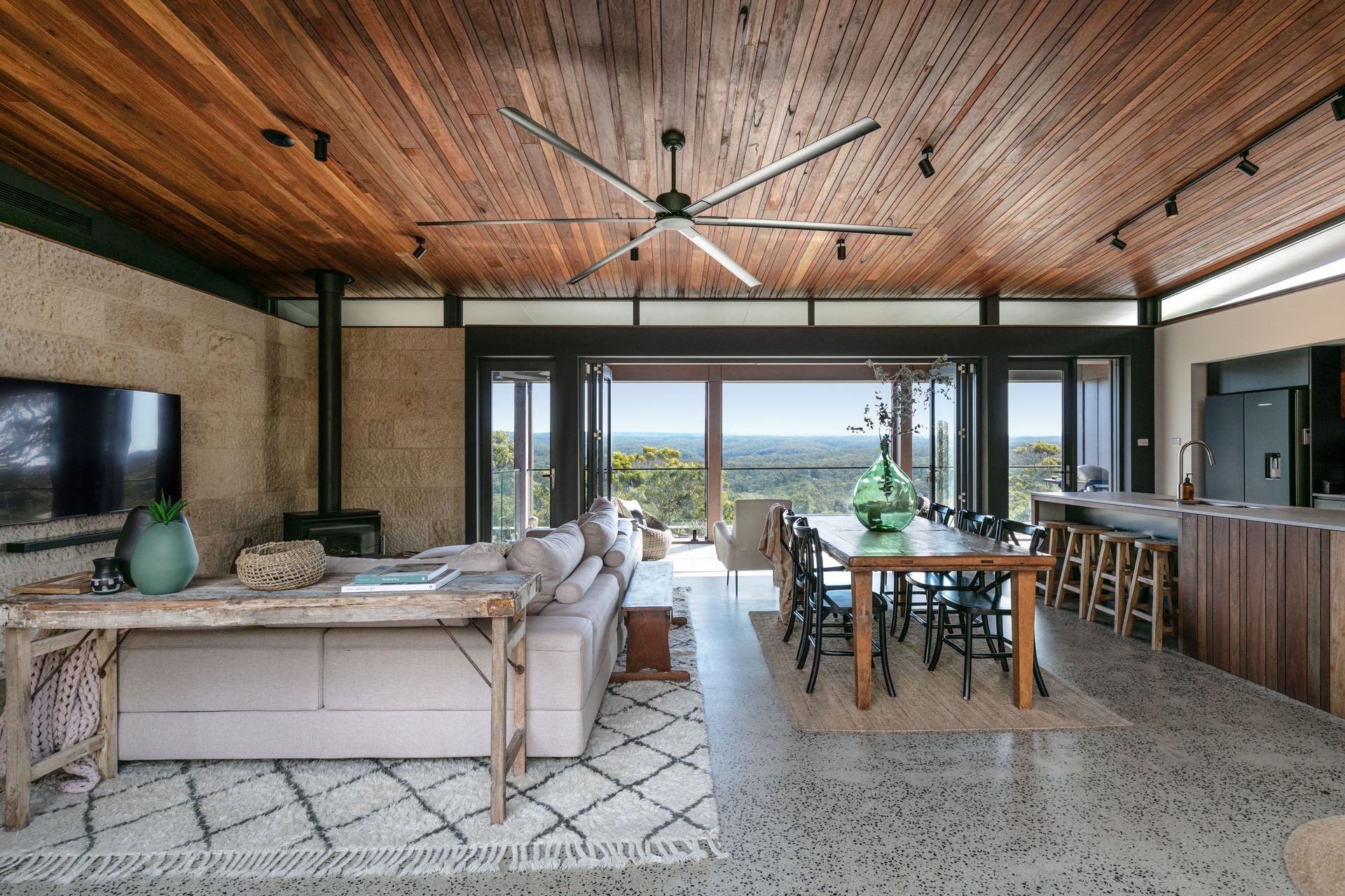 The earthy timber and stone materials continue inside.