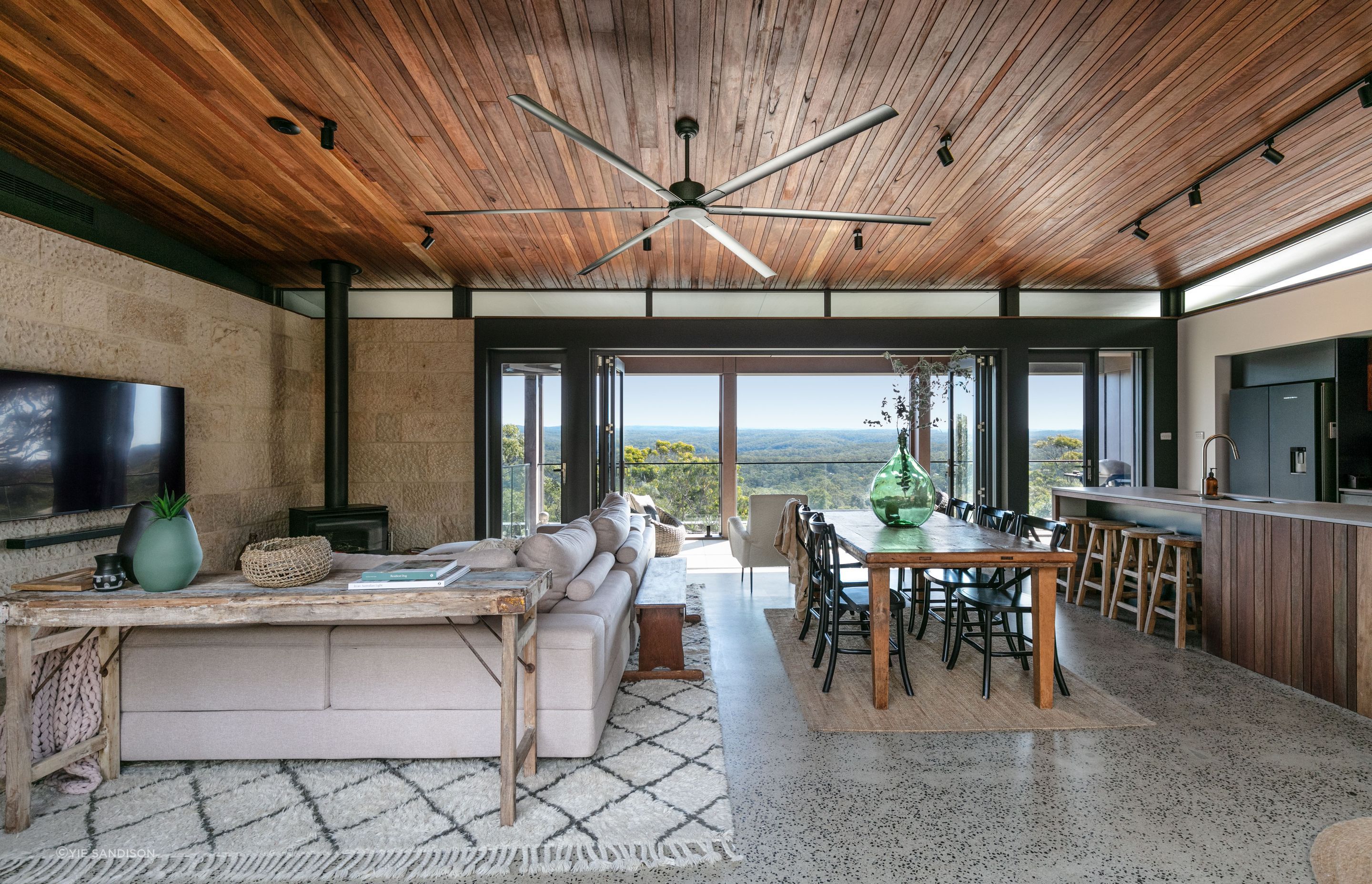 The earthy timber and stone materials continue inside.