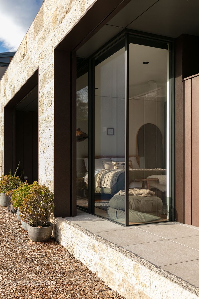 The deep recesses hide the bushfire shutters and allow for butt glass details to the bedroom.
