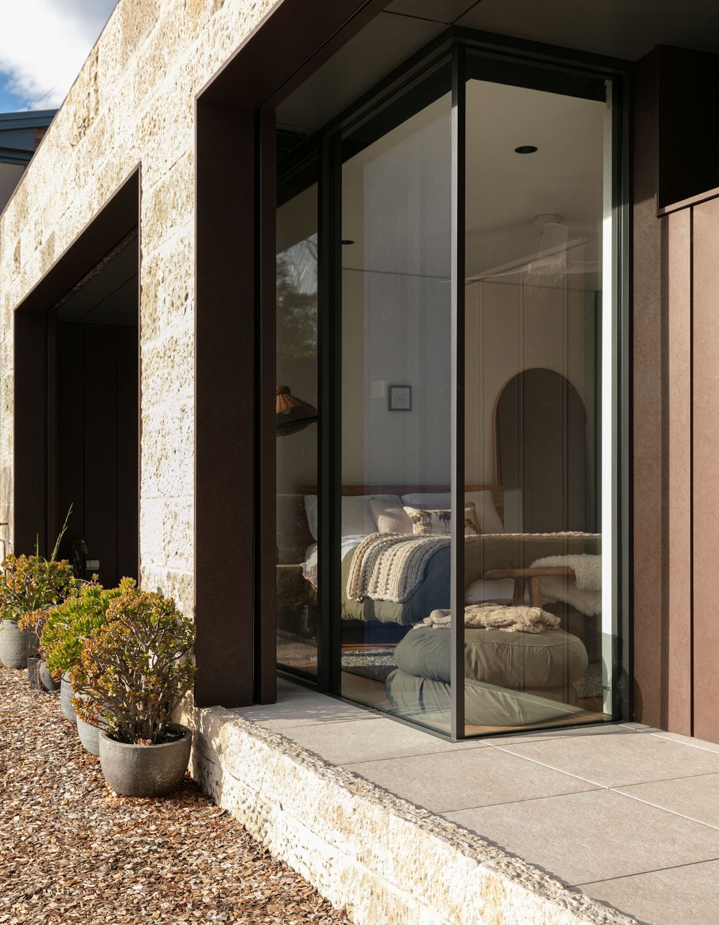 The deep recesses hide the bushfire shutters and allow for butt glass details to the bedroom.