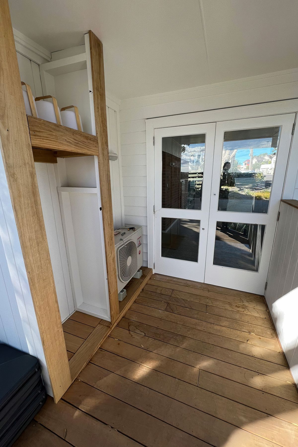 Custom outdoor storage solution built on the patio next to the backdoor and air conditioner