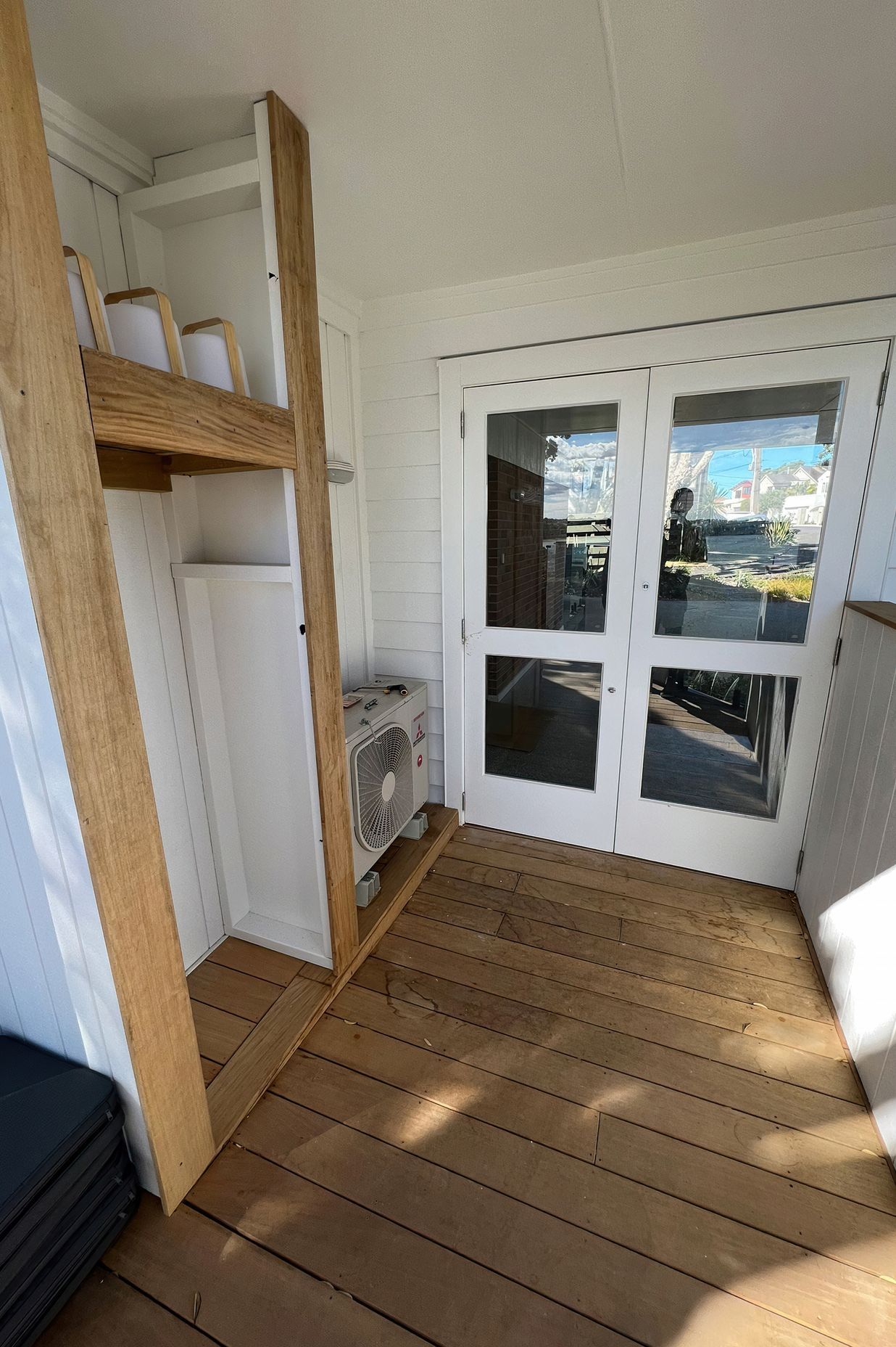 Custom outdoor storage solution built on the patio next to the backdoor and air conditioner