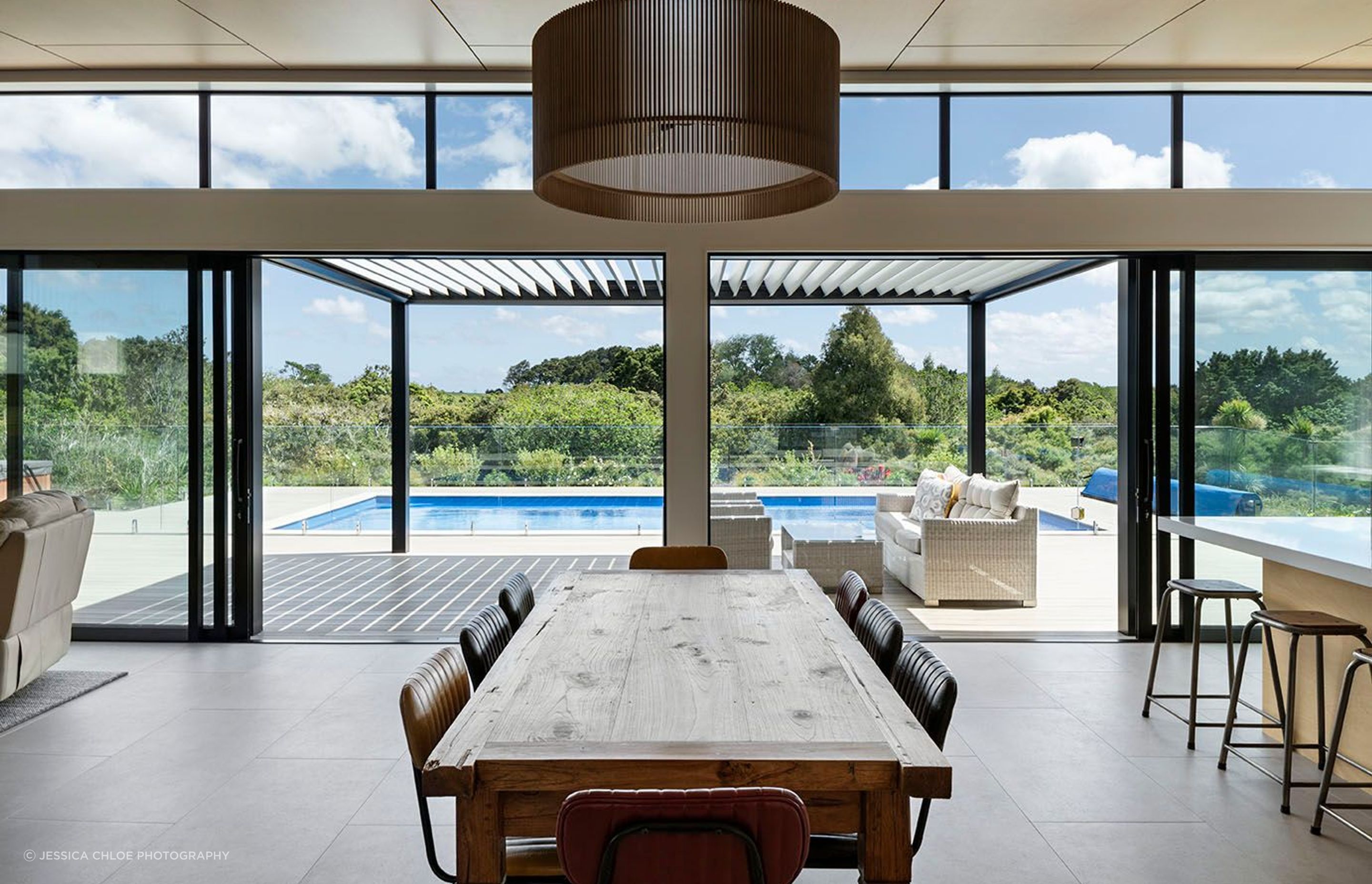 Living areas seamlessly connect to the decks and pool.