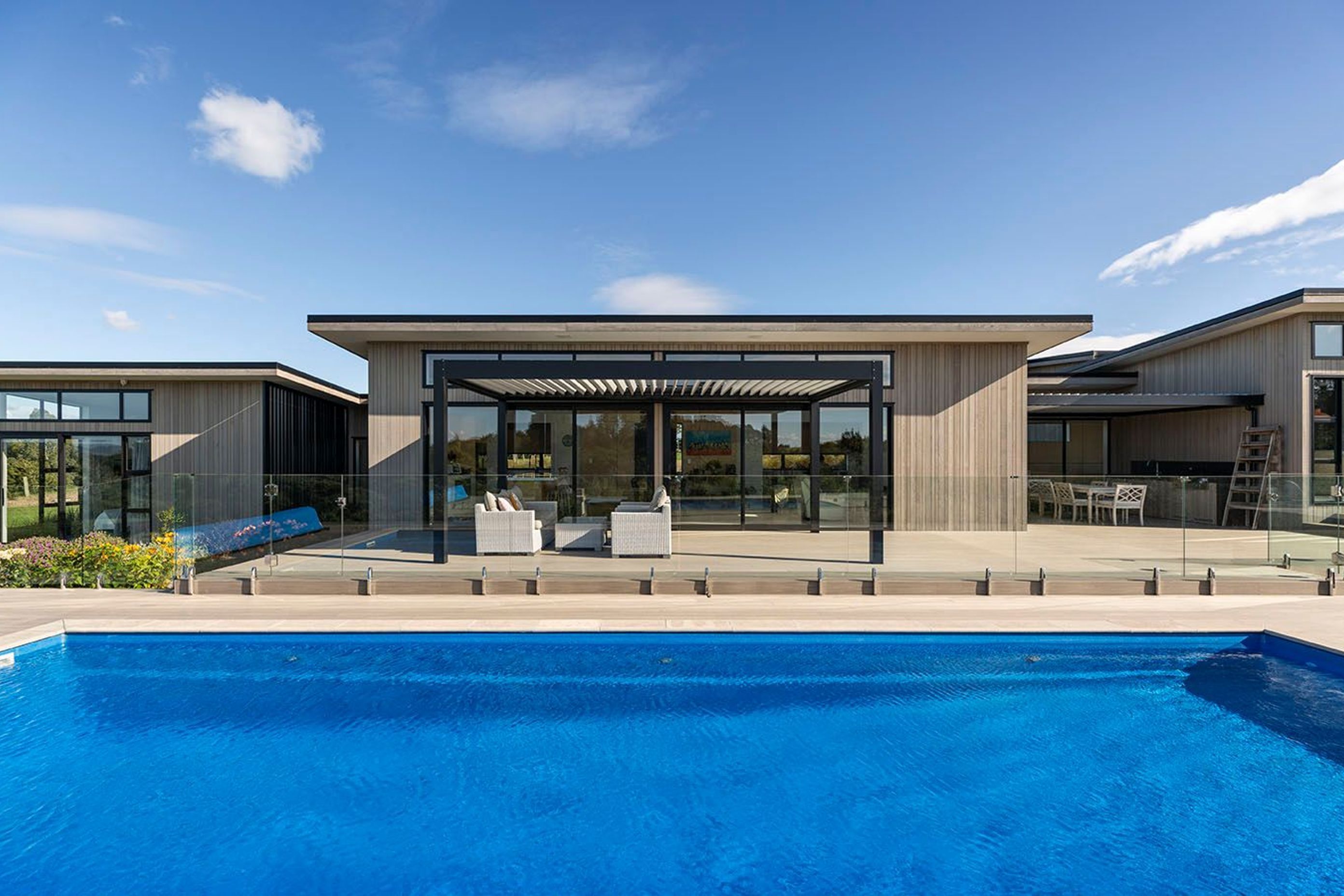 Blonded exterior cedar cladding adds a country feel to the mono pitch forms, which all open to the northern deck area and inground pool.