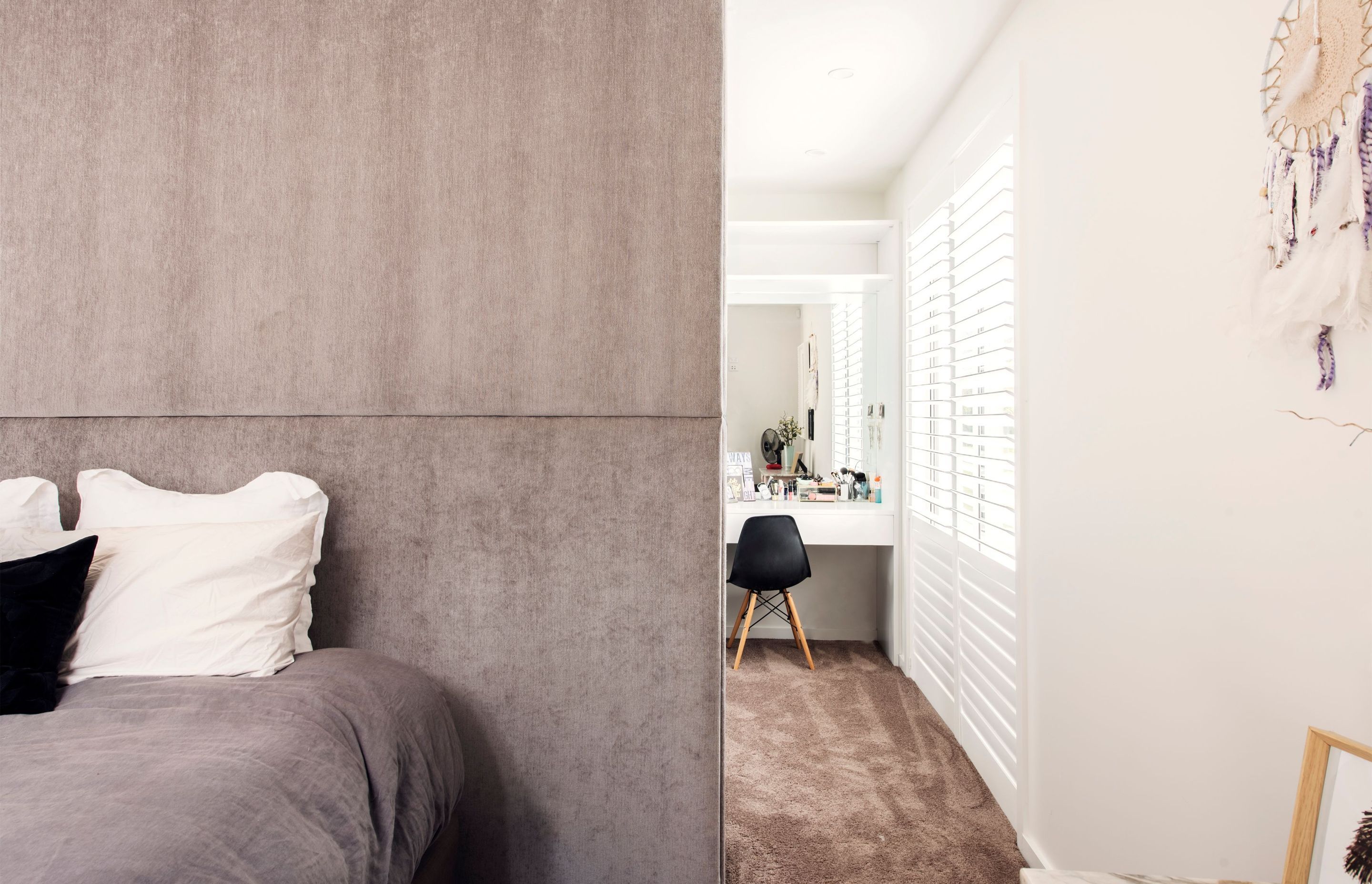 Interior designer Keith Vernon created a full-height upholstered headboard in fabric from Zinc Textile, in keeping with the owner's brief for simple, honest materials and a pared-back colour scheme.