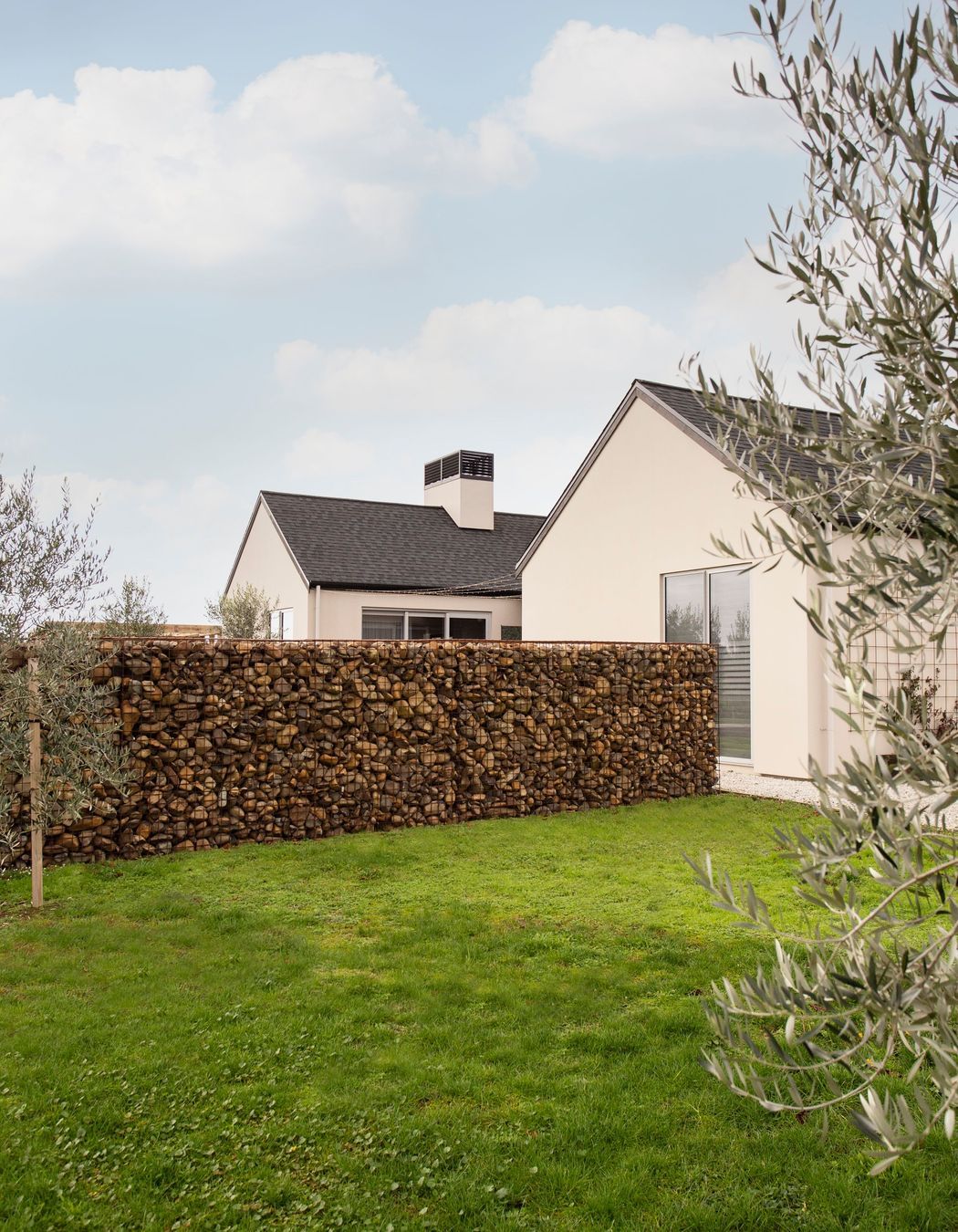 Gabion stone walls and olive trees add a final 'European touch' to the homes aesthetic.
