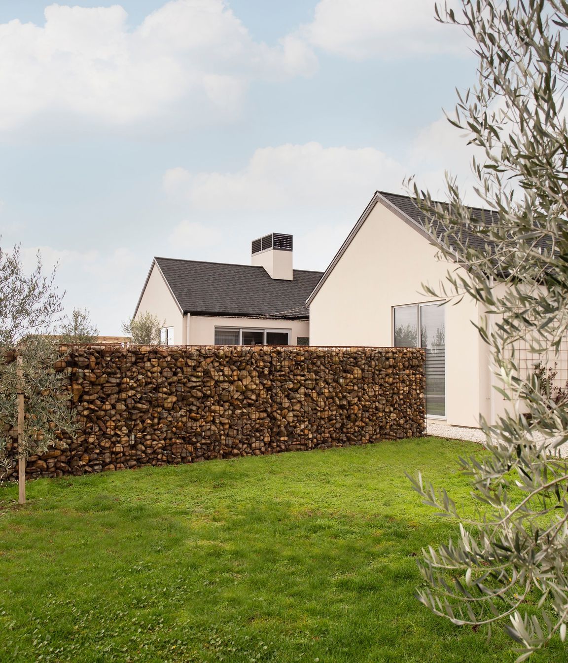 Gabion stone walls and olive trees add a final 'European touch' to the homes aesthetic.