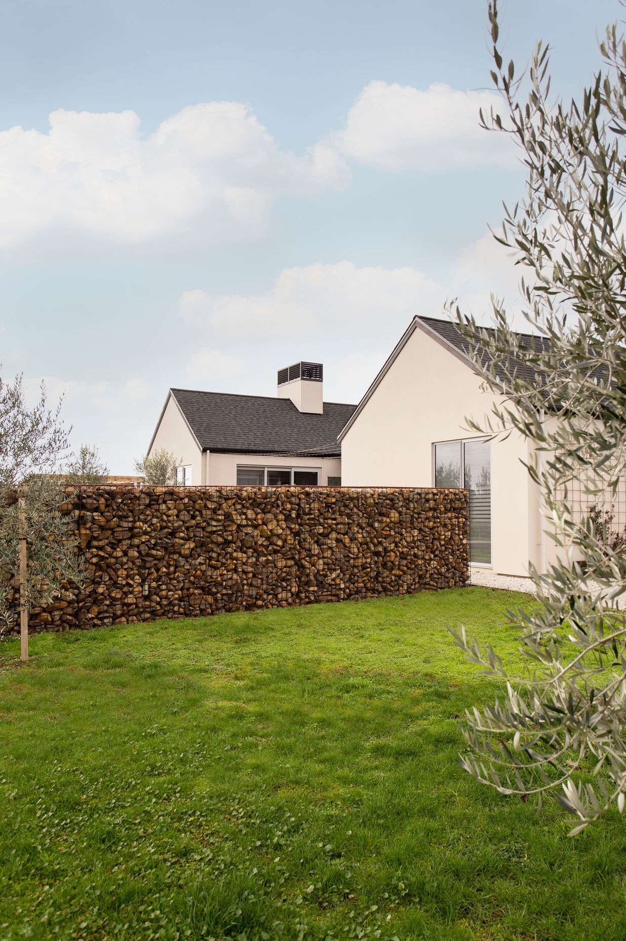 Gabion stone walls and olive trees add a final 'European touch' to the homes aesthetic.