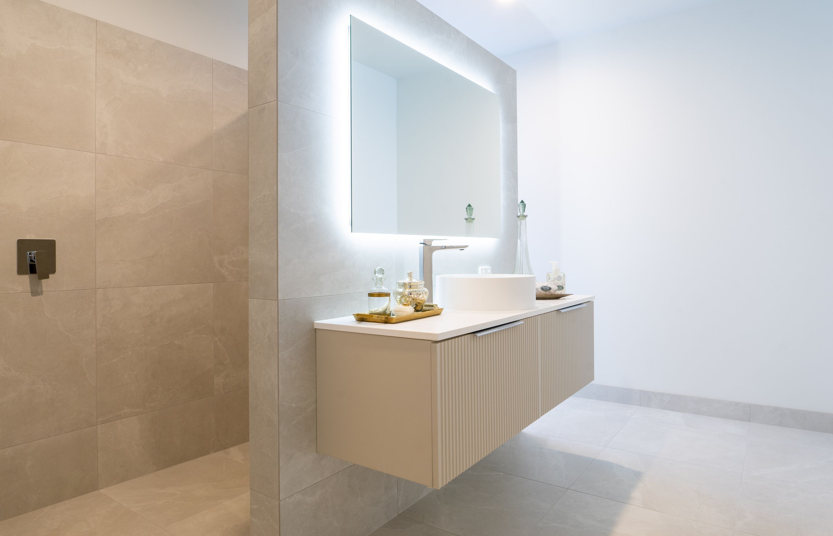 Neutral tones continue through to the designer bathrooms.