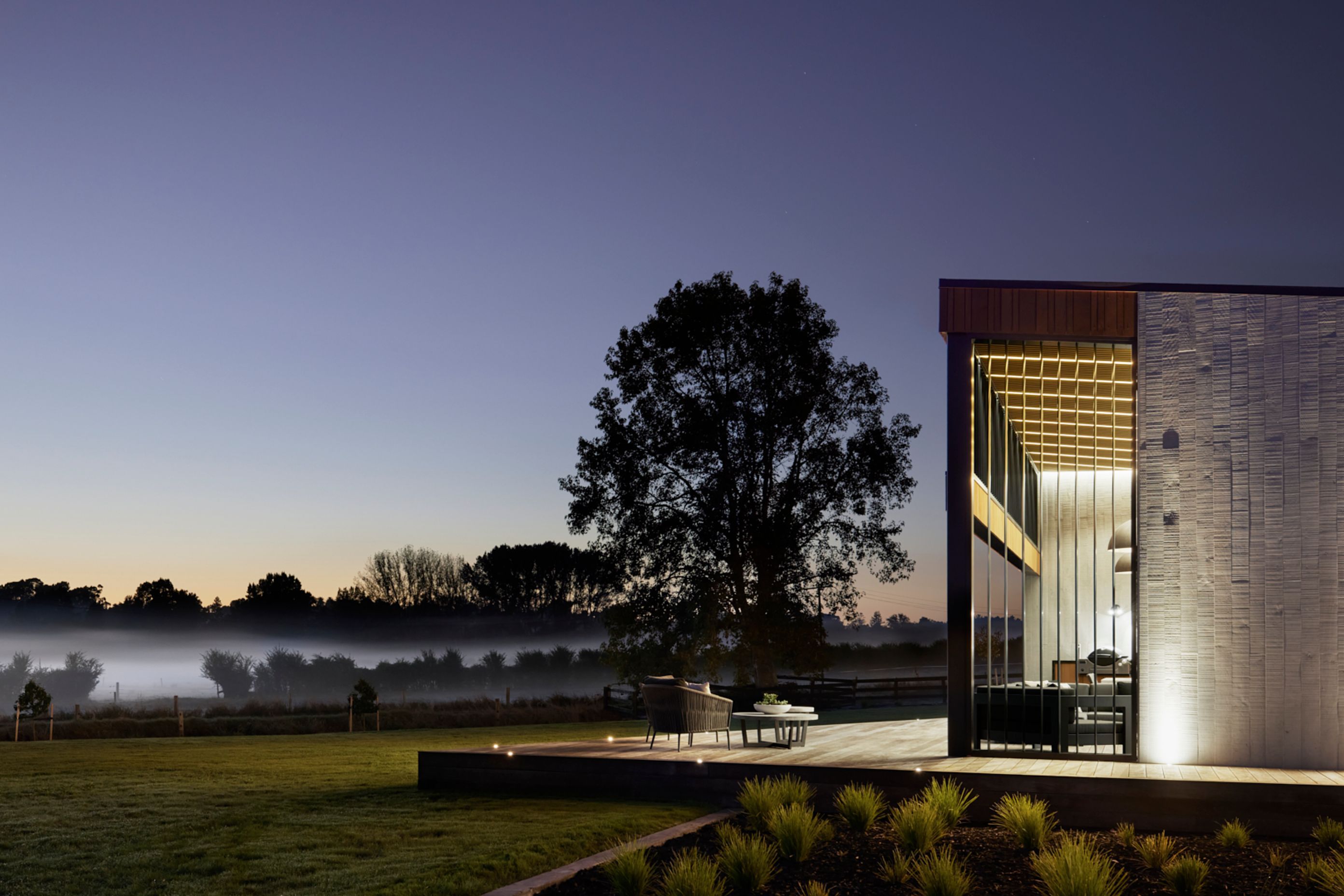 Lighting showcases the textural concrete at night.