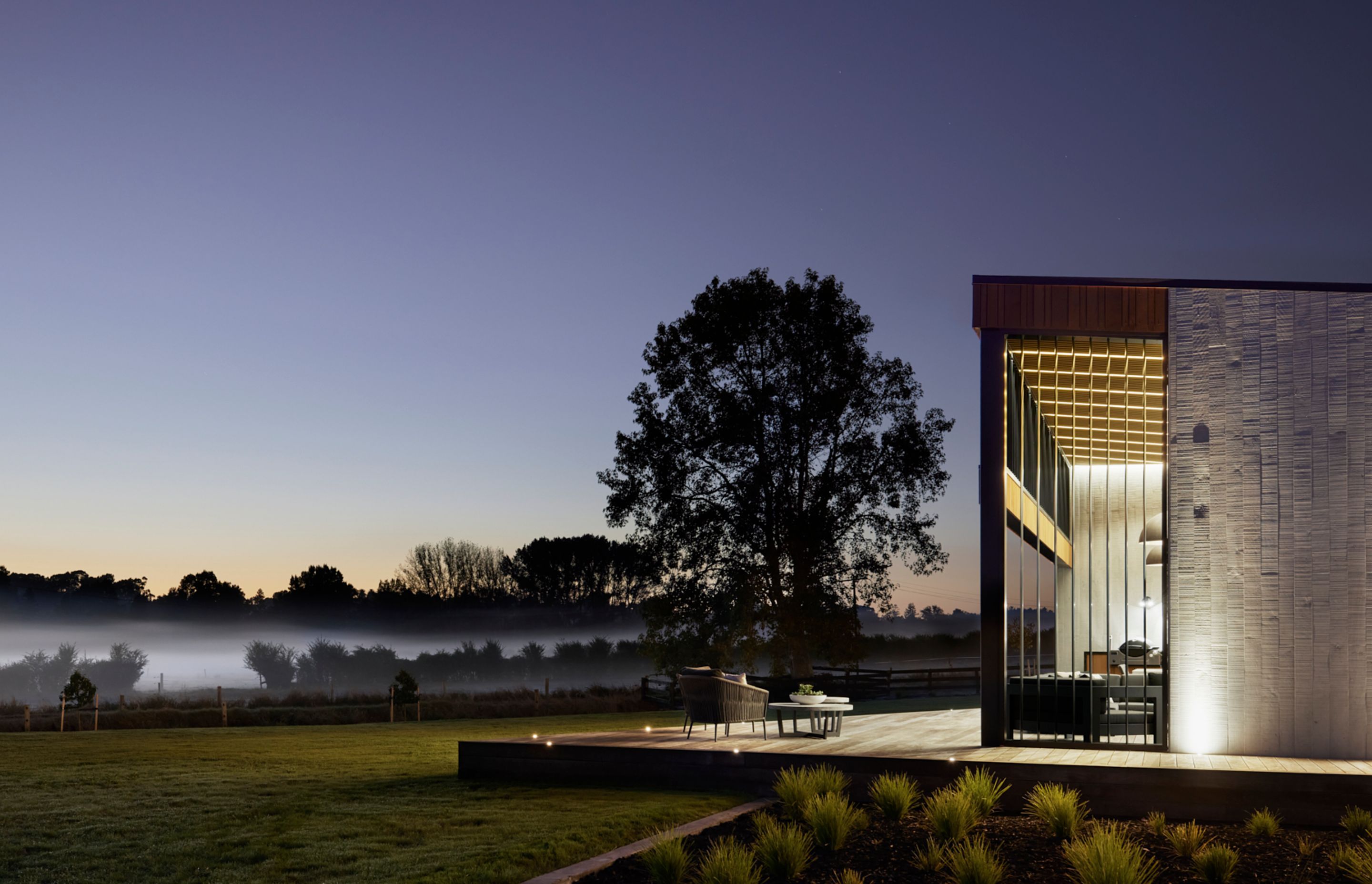 Lighting showcases the textural concrete at night.