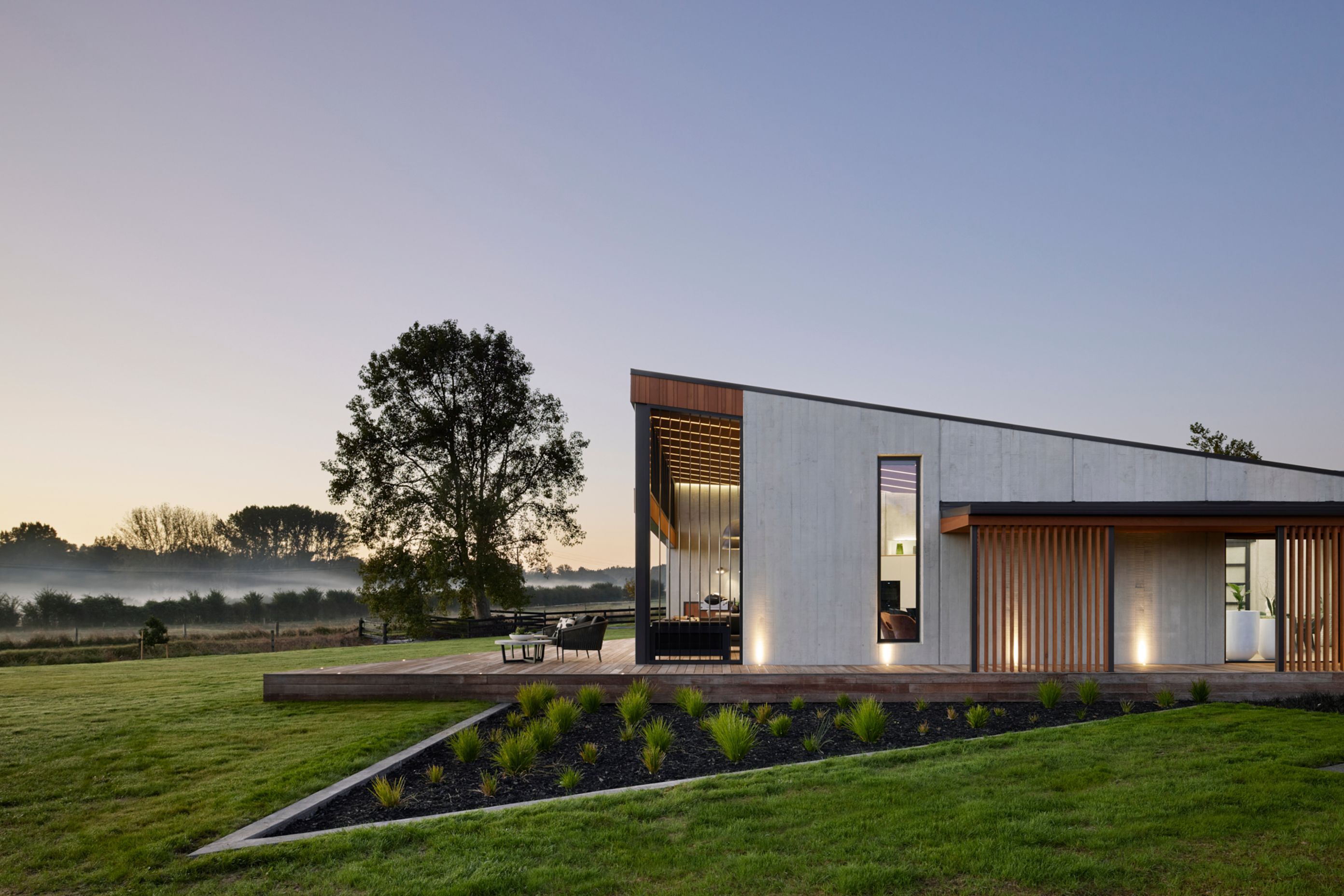 The exterior provides a glimpse as to what expect inside: natural tones and textures and a soaring ceiling in the living pavilion.