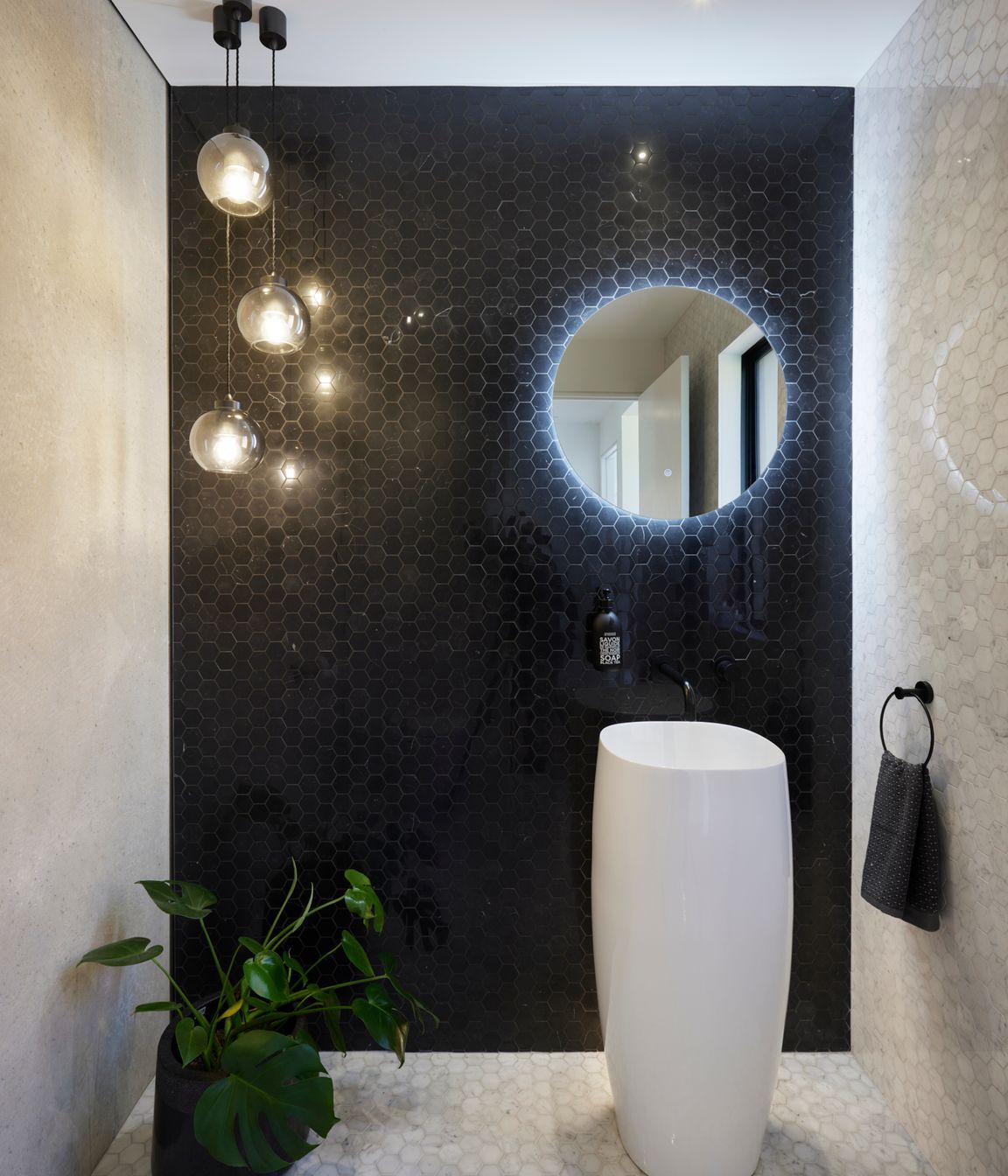 The bathrooms maintain a monochrome palette.