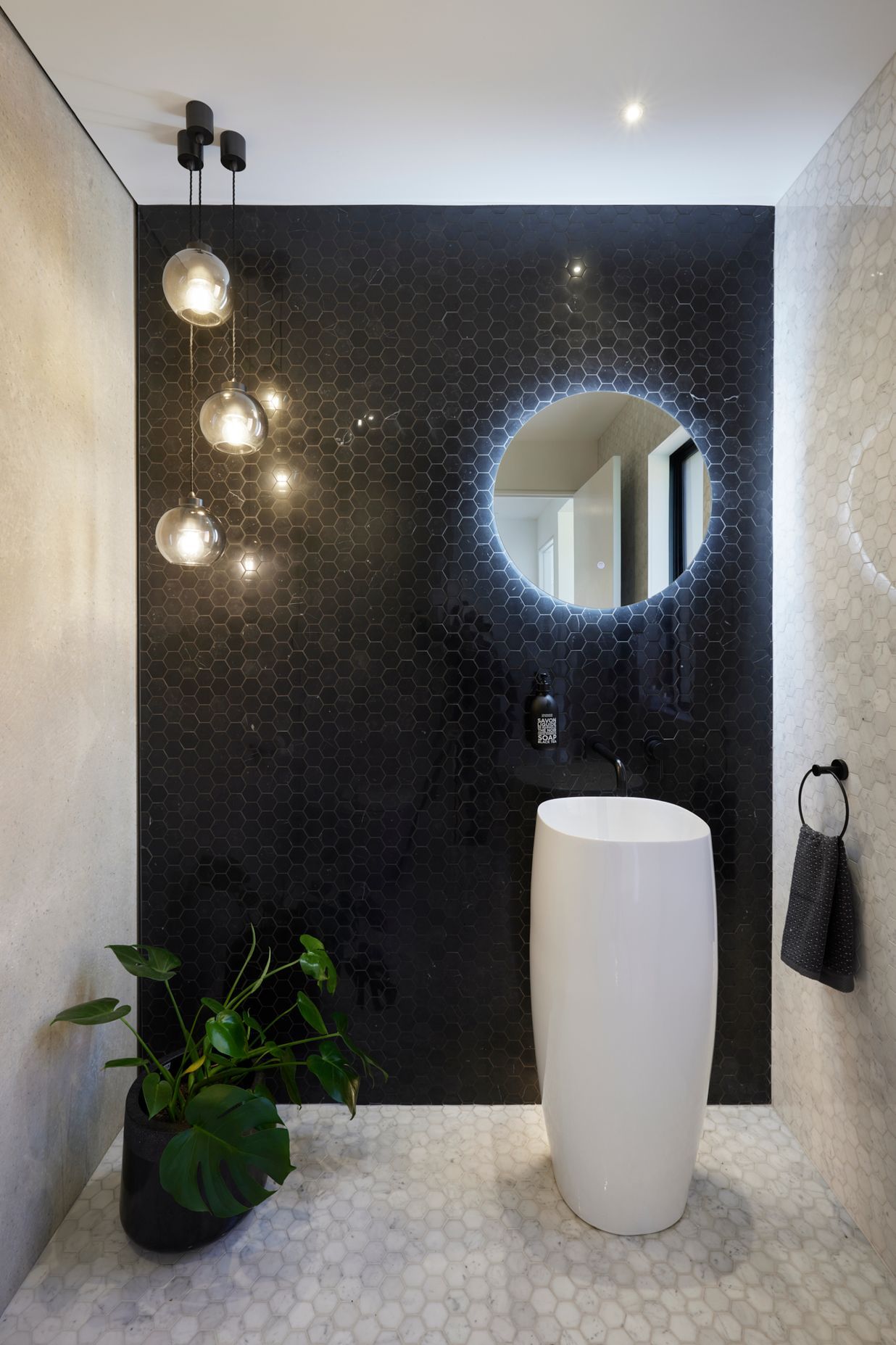 The bathrooms maintain a monochrome palette.