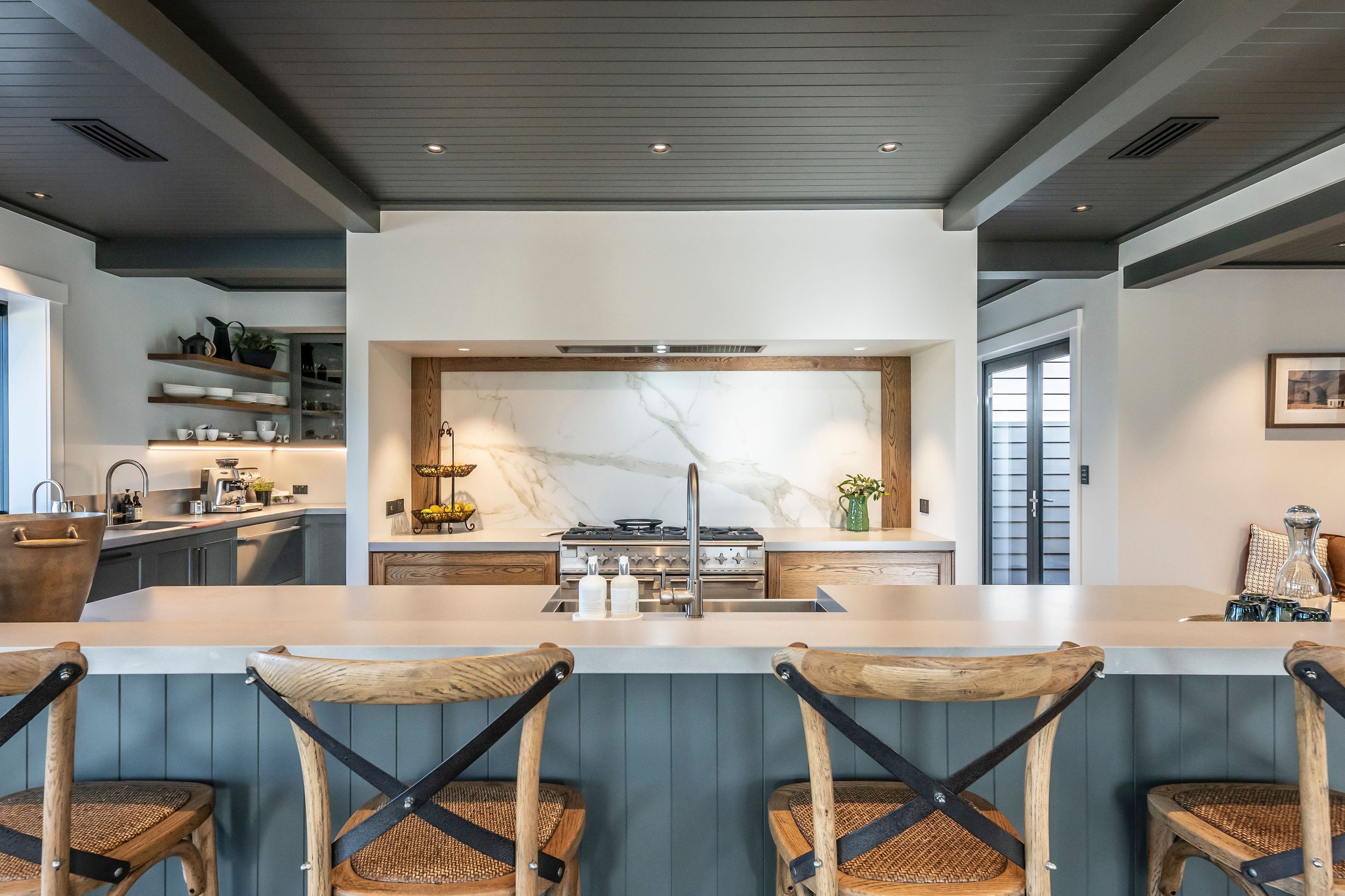 A large island bench separates the living area from the well-appointed kitchen.
