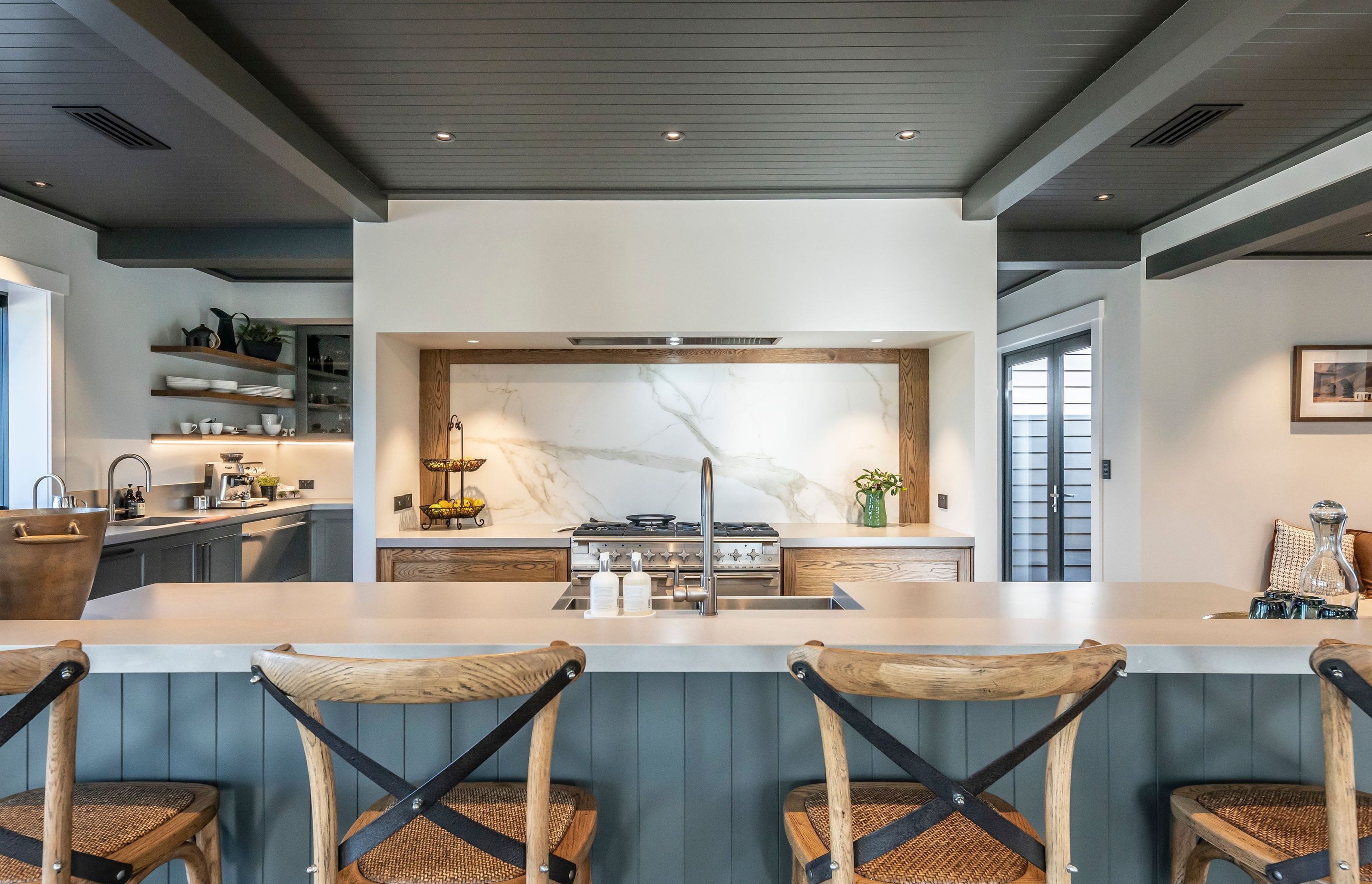 A large island bench separates the living area from the well-appointed kitchen.