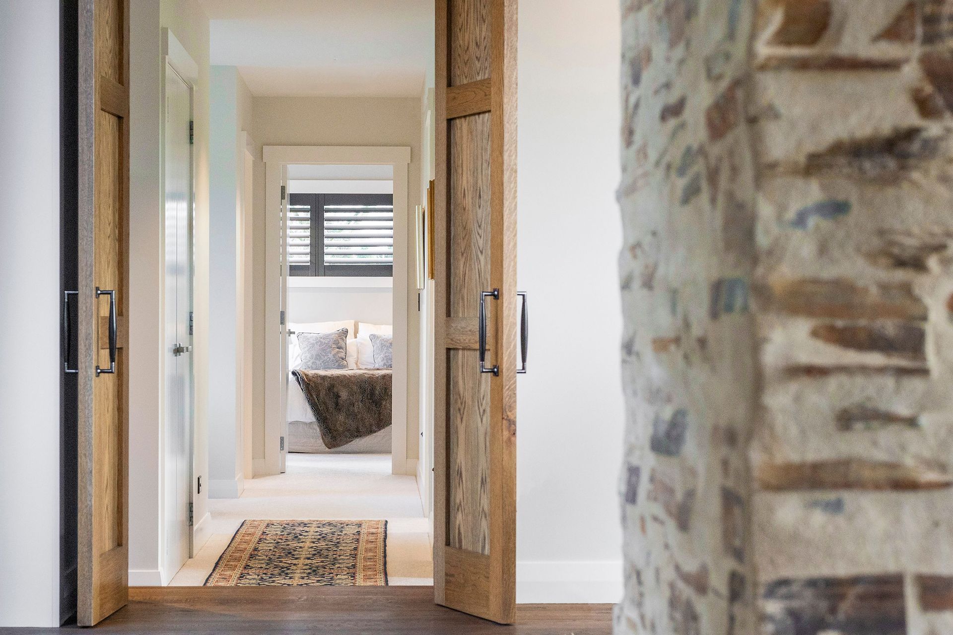 Natural timbers and bagged stone off set the otherwise neutral palette, creating a light, airy interior with elements of textural interest.