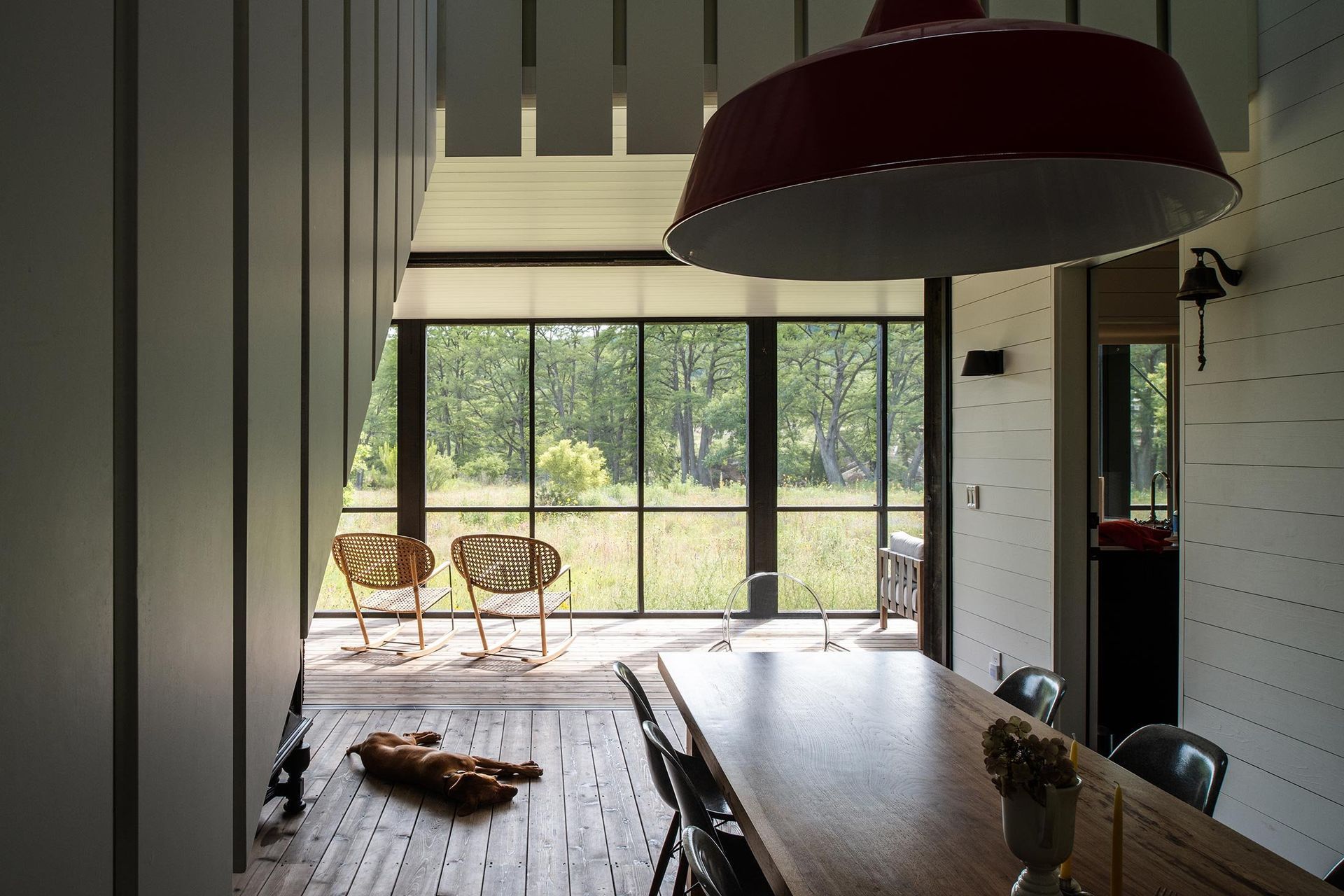 12CampFrioCuppettKilpatrickArchitectureandInteriorDesignindoor-outdoor-dining-room-wood-table-modern-chairs-nature-view.jpg