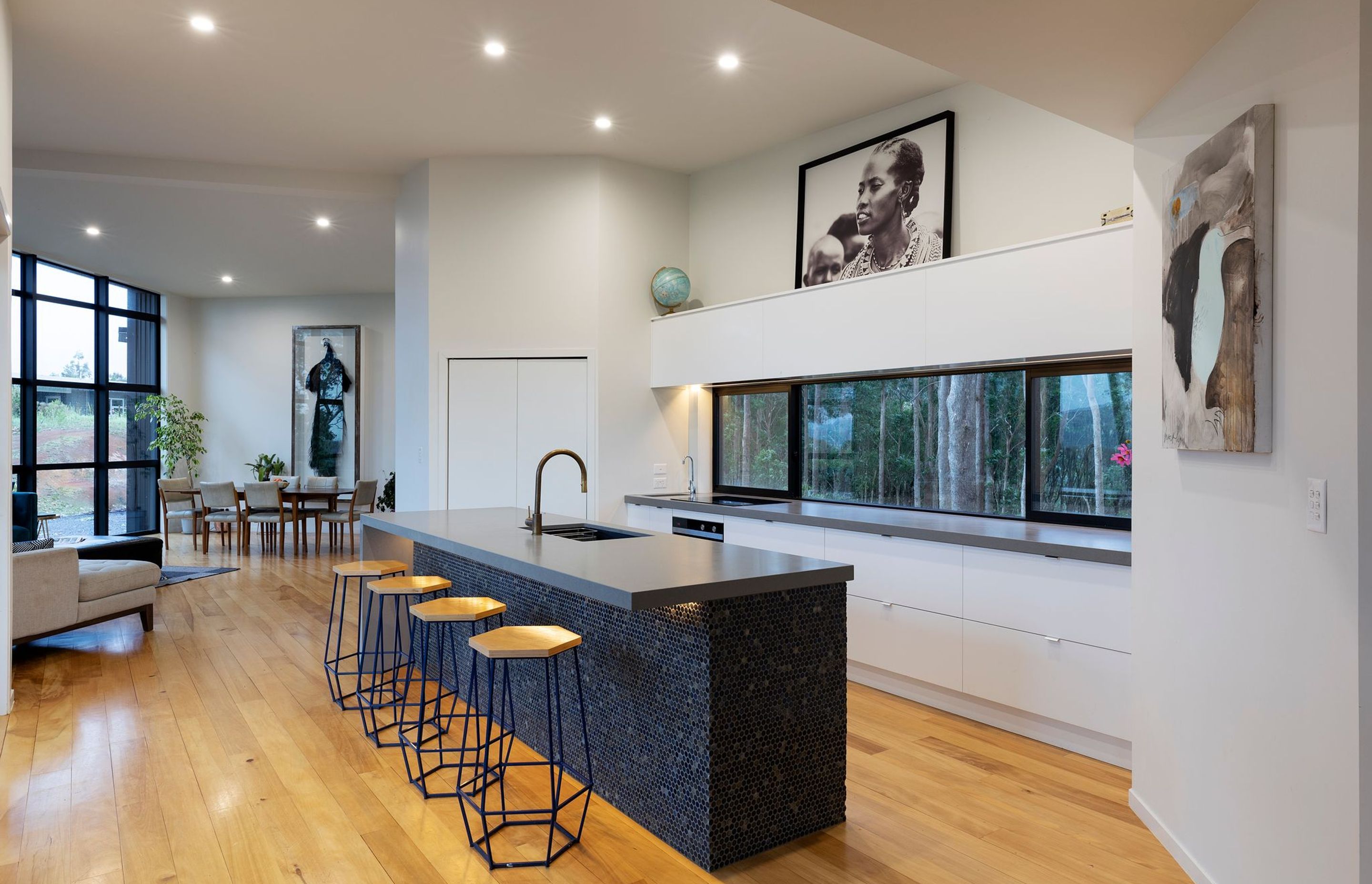 A pantry space serves to contain the general clutter, leaving the main kitchen area streamlined and sleek. The window 'splashback' provides another opportunity to engage with the gum trees.