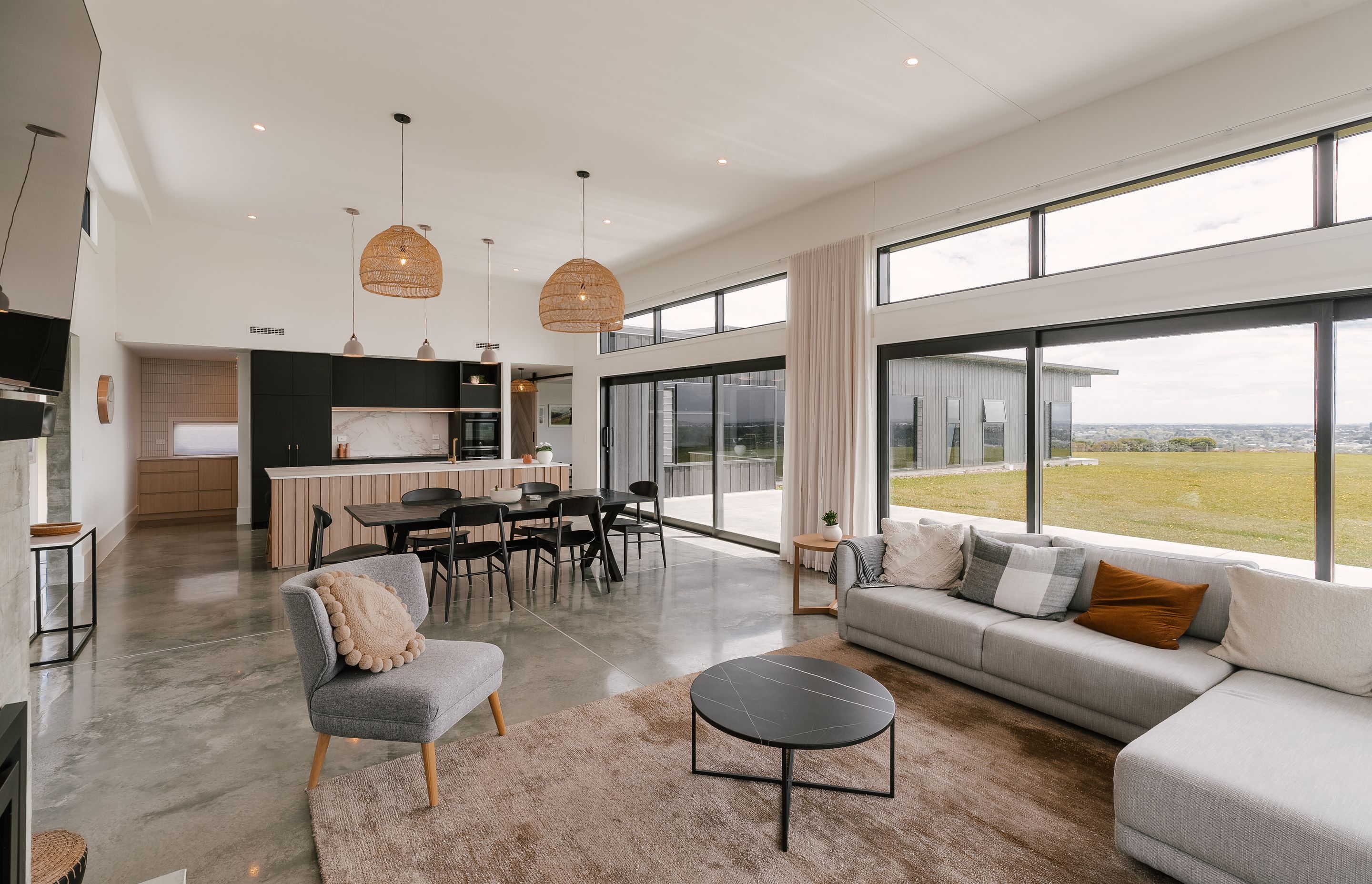A beautiful Palmerston North Oasis streaming with natural lighting over a soft and bold contemporary kitchen