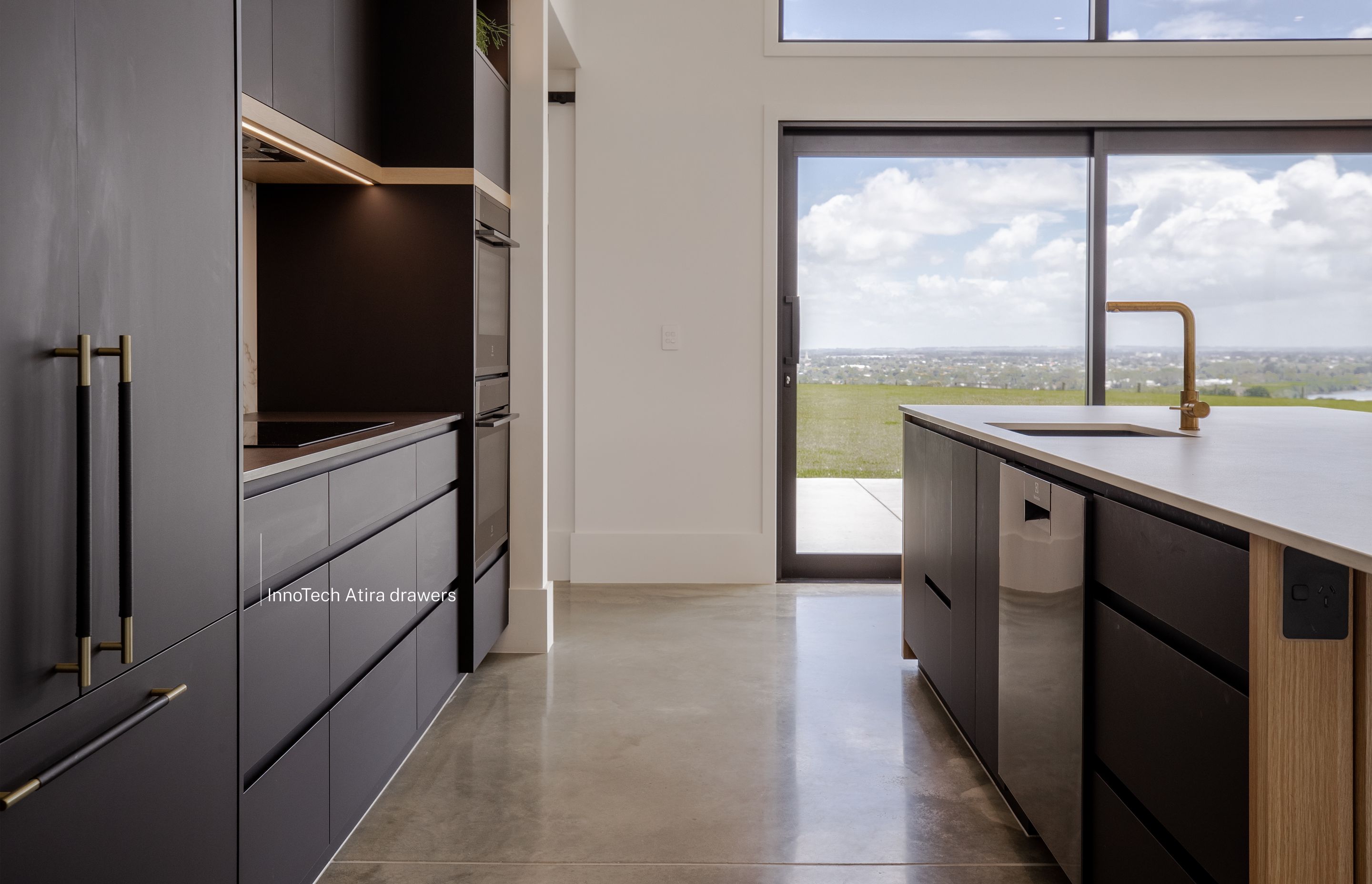 Stunning views of the city from the main kitchen that uses matt black materials for a feature kitchen.
