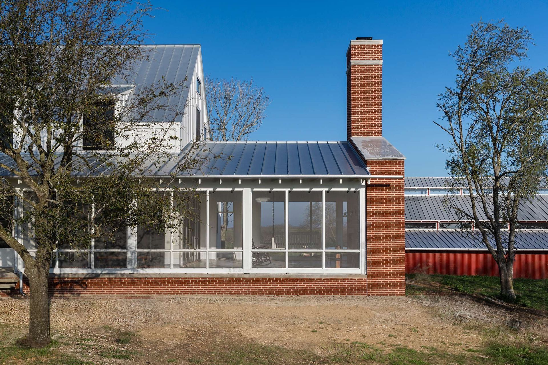 5PendletonFarmCuppettKilpatrickArchitectureandInteriorDesignaustin-tx-farmhouse-screened-porch-brick-chimney.jpg