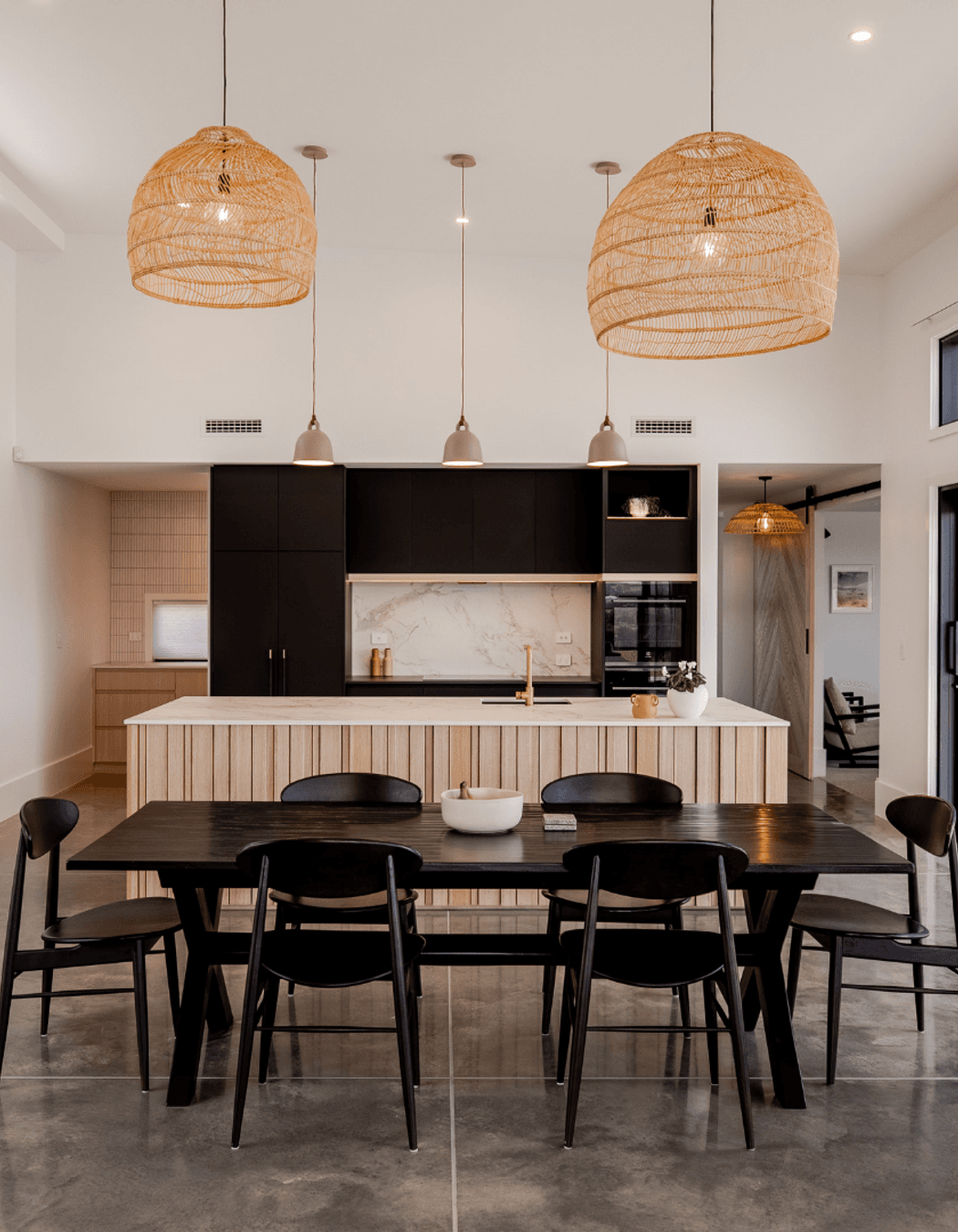 Layered dark kitchen with a warm scullery that uses natural elements