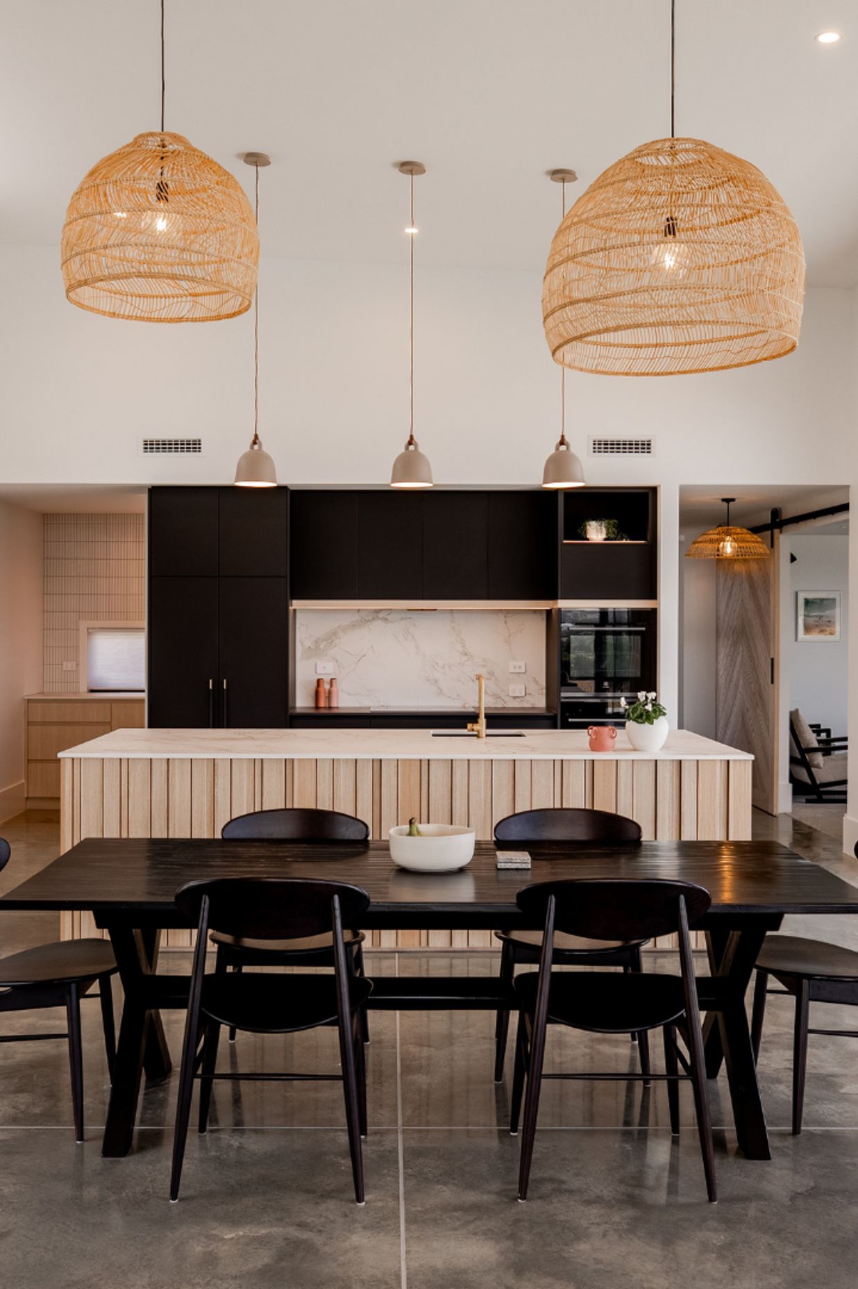 Layered dark kitchen with a warm scullery that uses natural elements