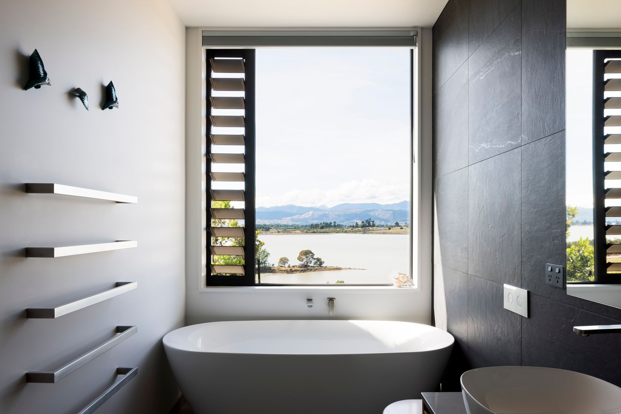 From the bathm a perfectly placed window centres on an idyllic view of Waimea Inlet.