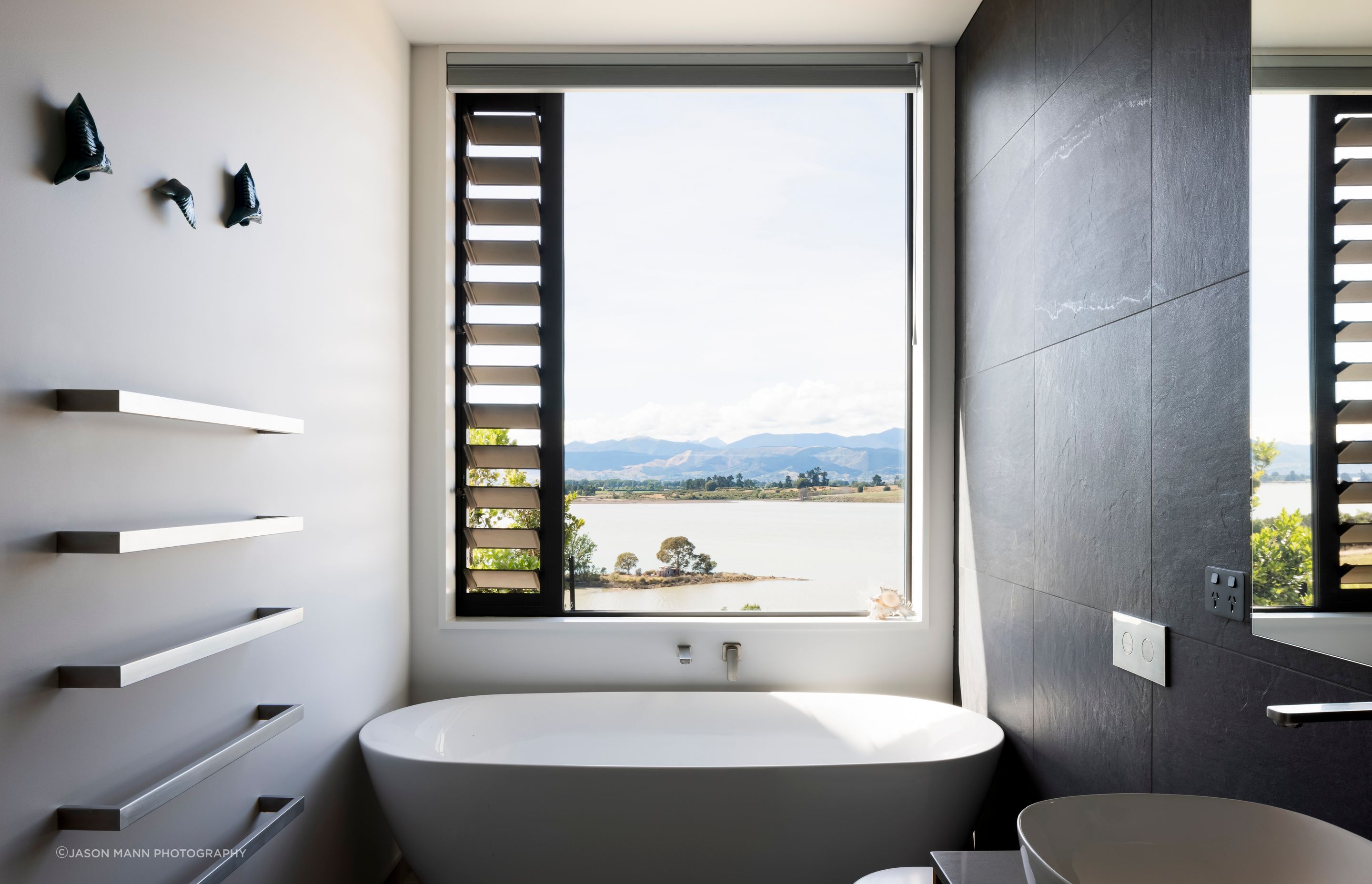 From the bathm a perfectly placed window centres on an idyllic view of Waimea Inlet.