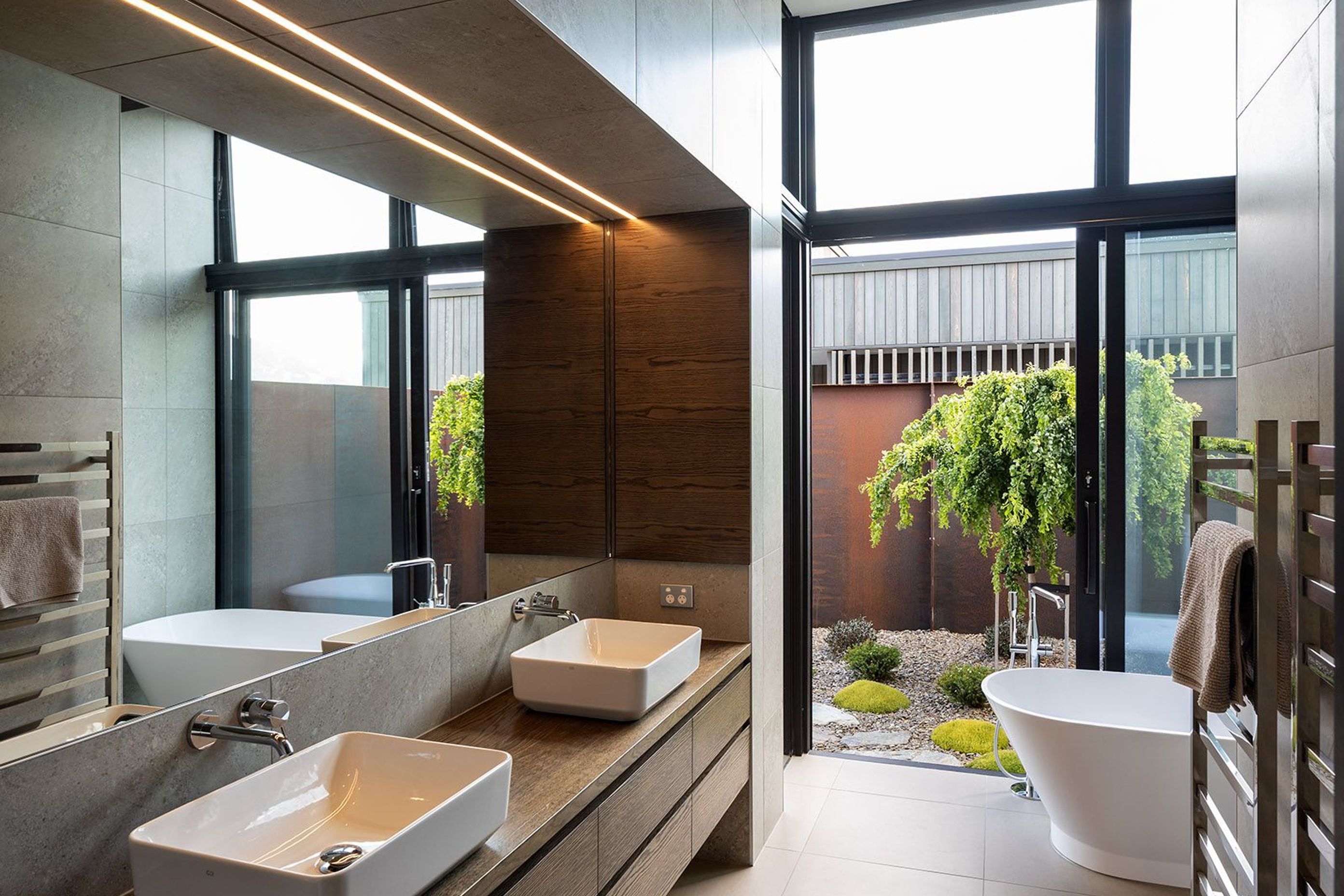 The master ensuite enjoys direct access to a private courtyard garden with views towards Roys Peak, which can be enjoyed from the bathtub.