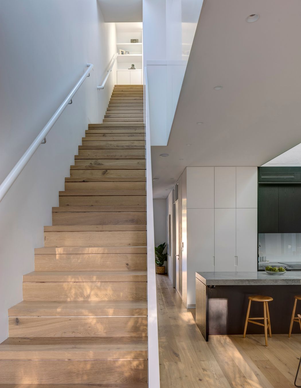 The stairs are arranged in sequence, creating expansive space within a compact footprint.