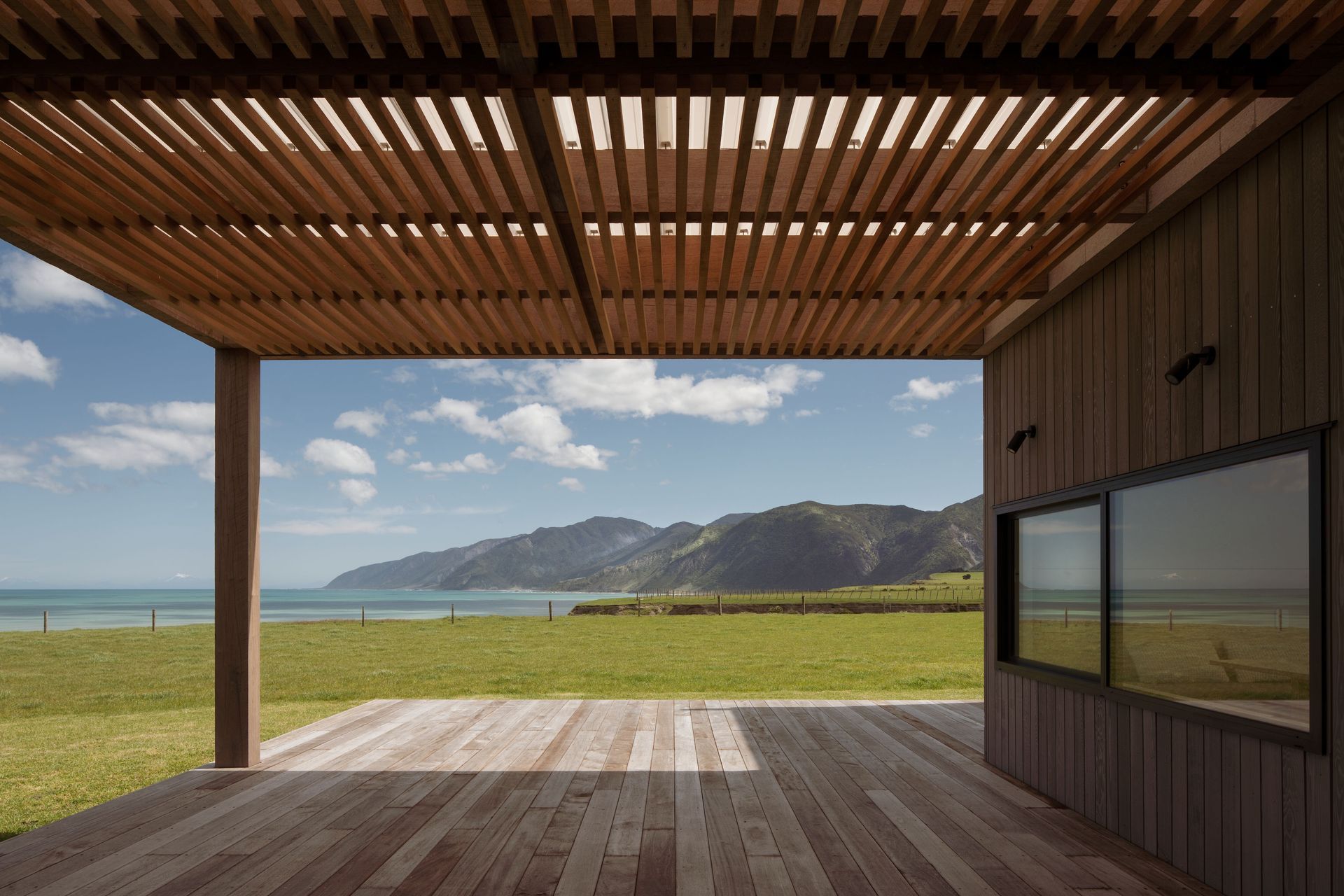 The design of the house needed to be robust enough to withstand the southerly storms that roll in off the Pacific Ocean but warm and inviting enough to allow the owners to take advantage of the natural elements, too.