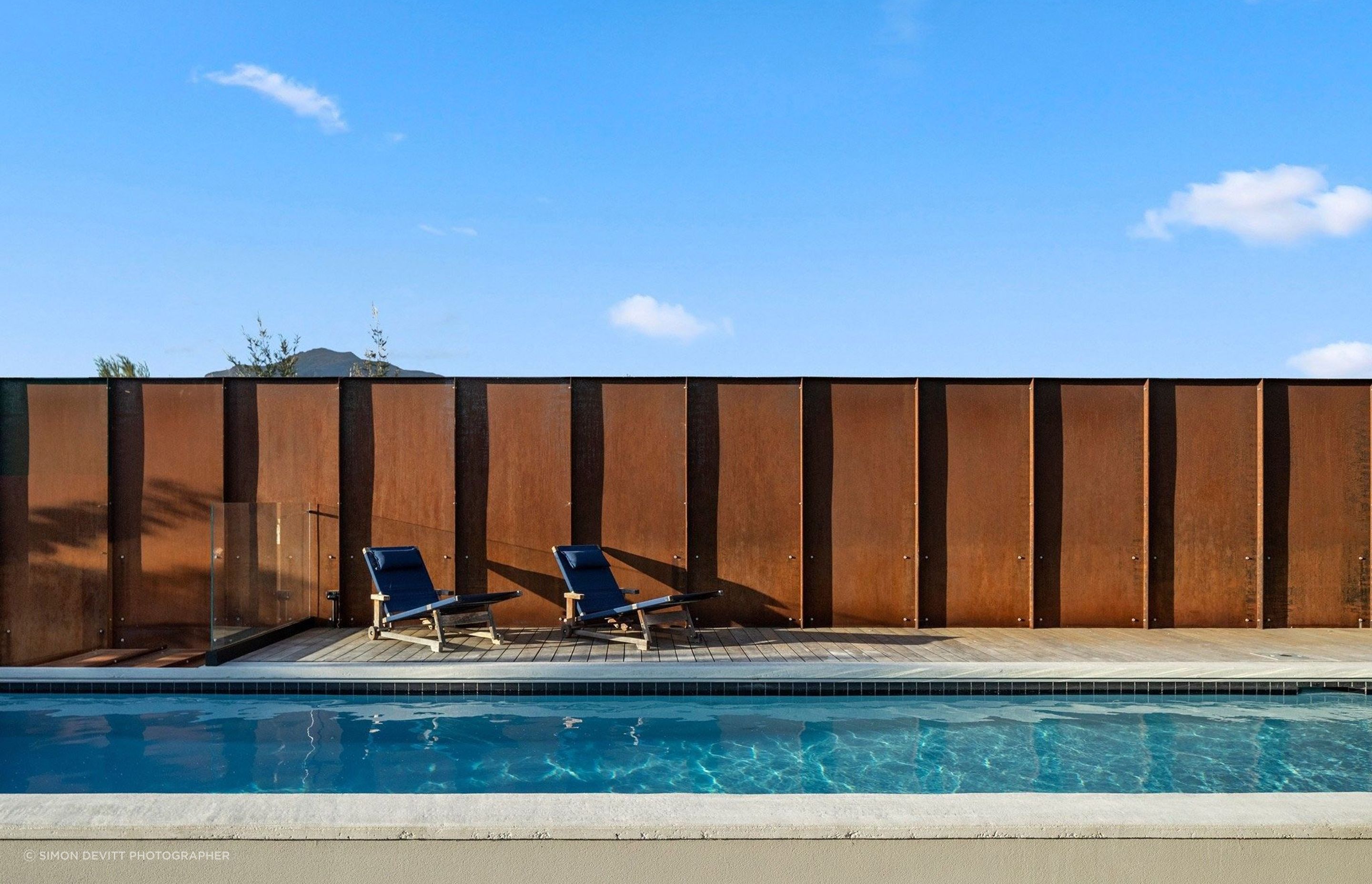 Custom Corten panels have been used to create a fence that not only provides privacy but will also continue to patina over time adding an element of permanency and immutability.