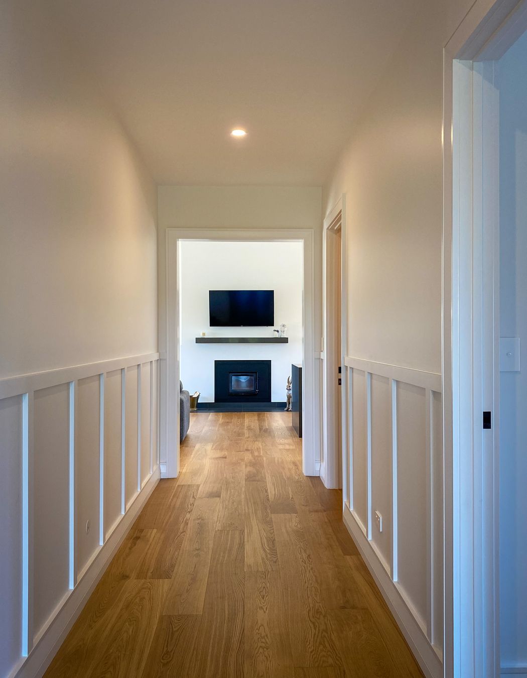 A wood burning fireplace takes pride and place centrally in the entry and main living area.