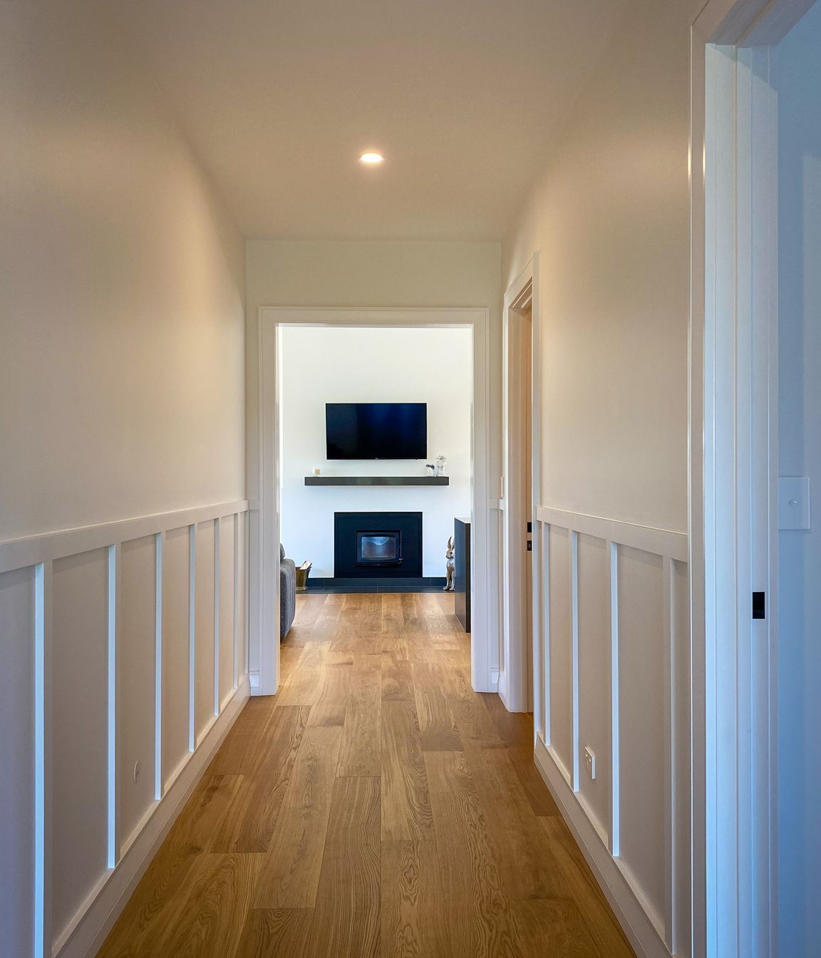 A wood burning fireplace takes pride and place centrally in the entry and main living area.
