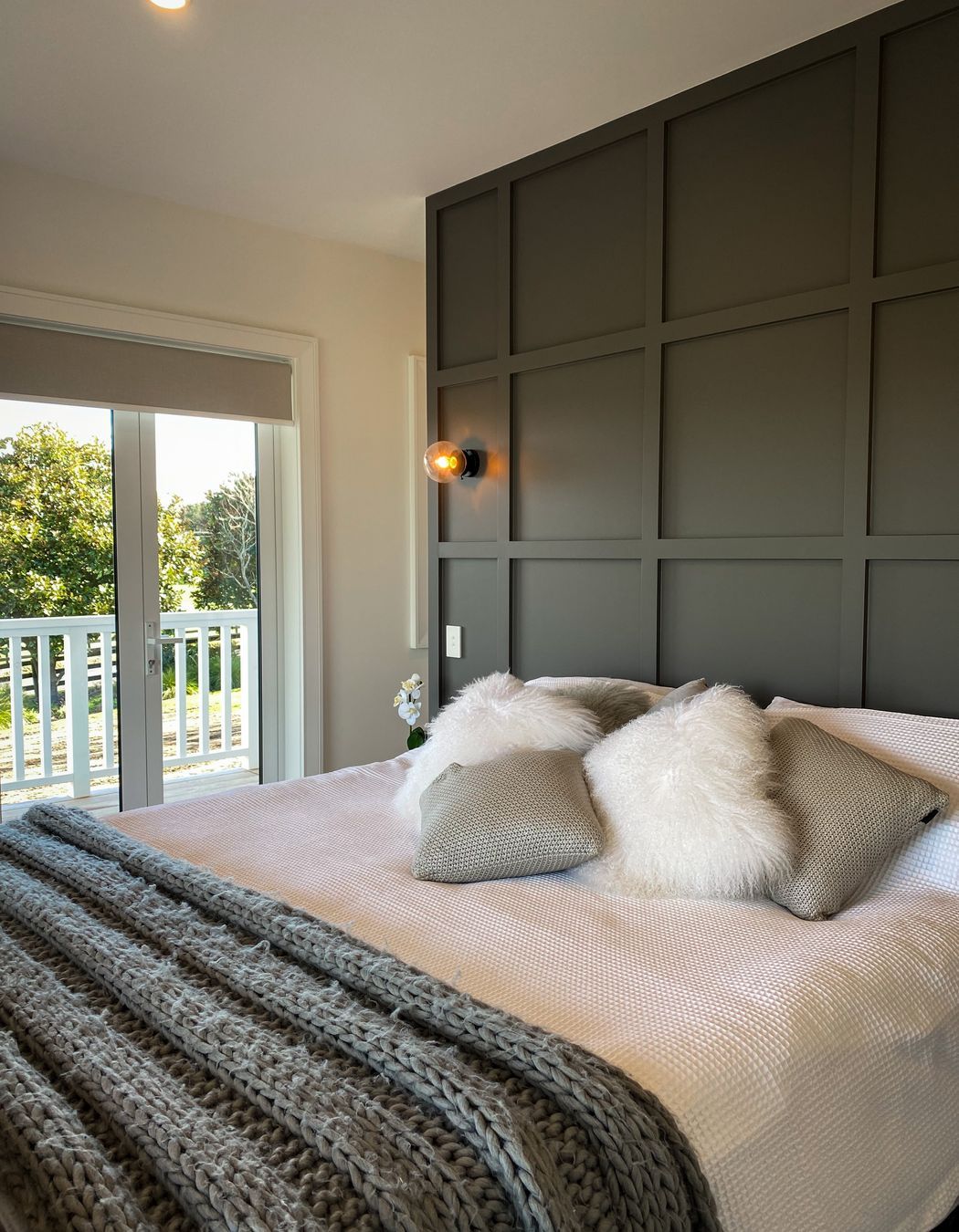 The master suite has a timber detailed feature wall leading to the walk in wardrobes.