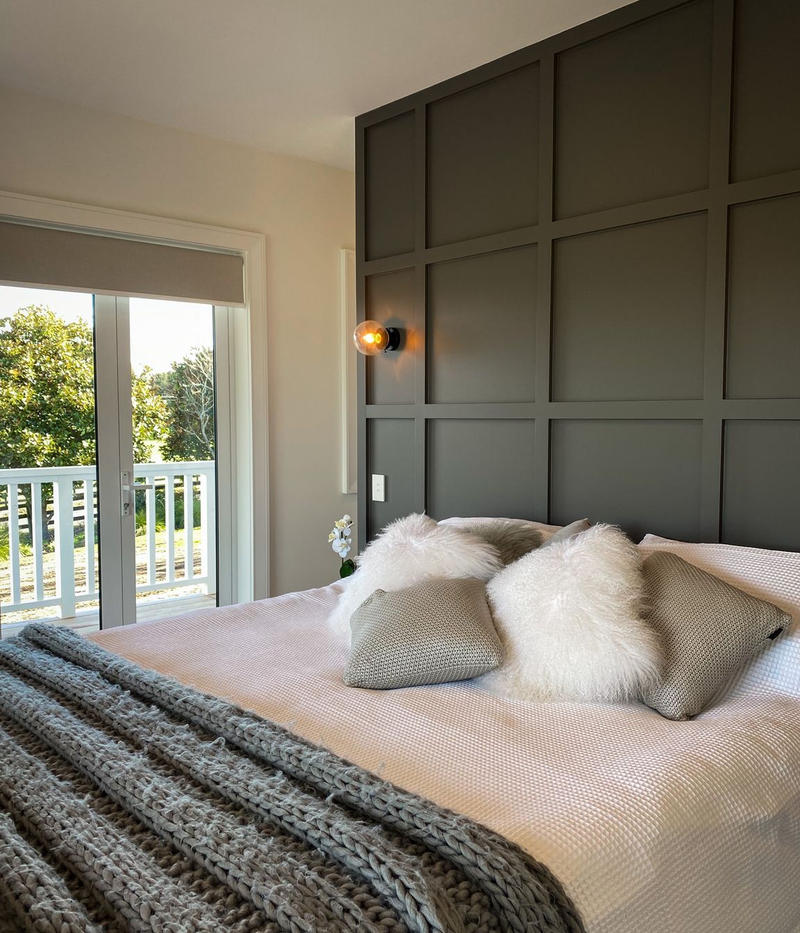 The master suite has a timber detailed feature wall leading to the walk in wardrobes.