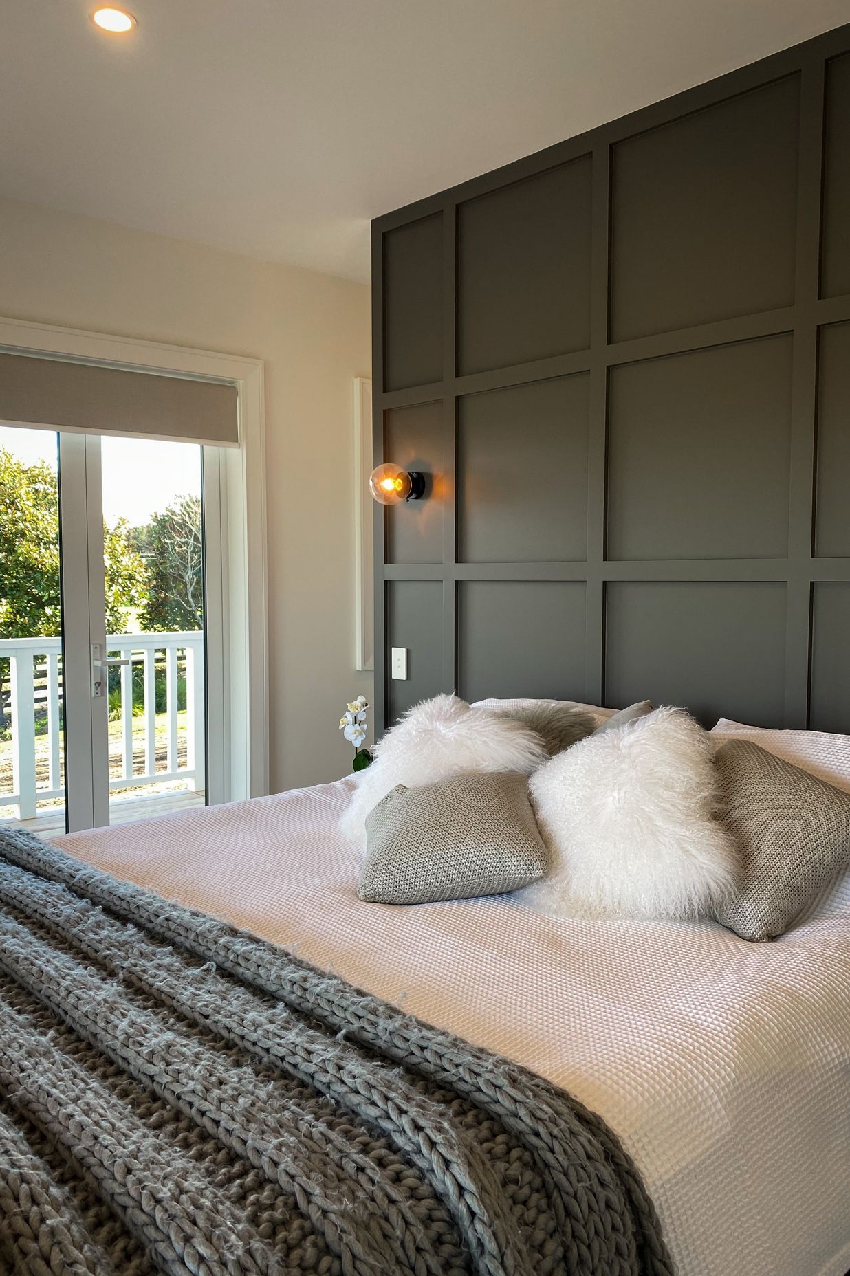 The master suite has a timber detailed feature wall leading to the walk in wardrobes.