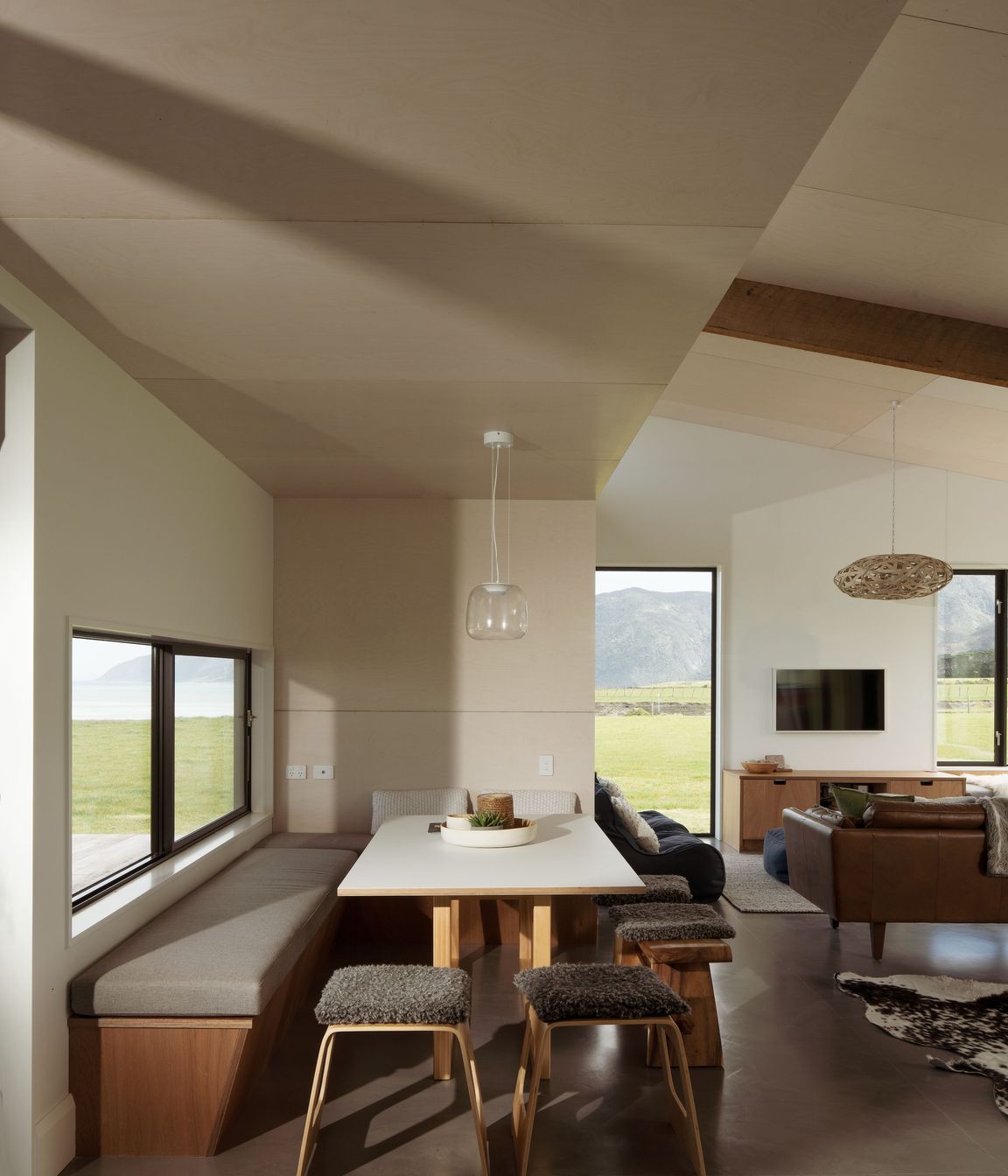Blonde Ambition ply on the ceiling adds a subtle, textural element to the interior, while the polished concrete floor helps the structure to feel connected to the land.
