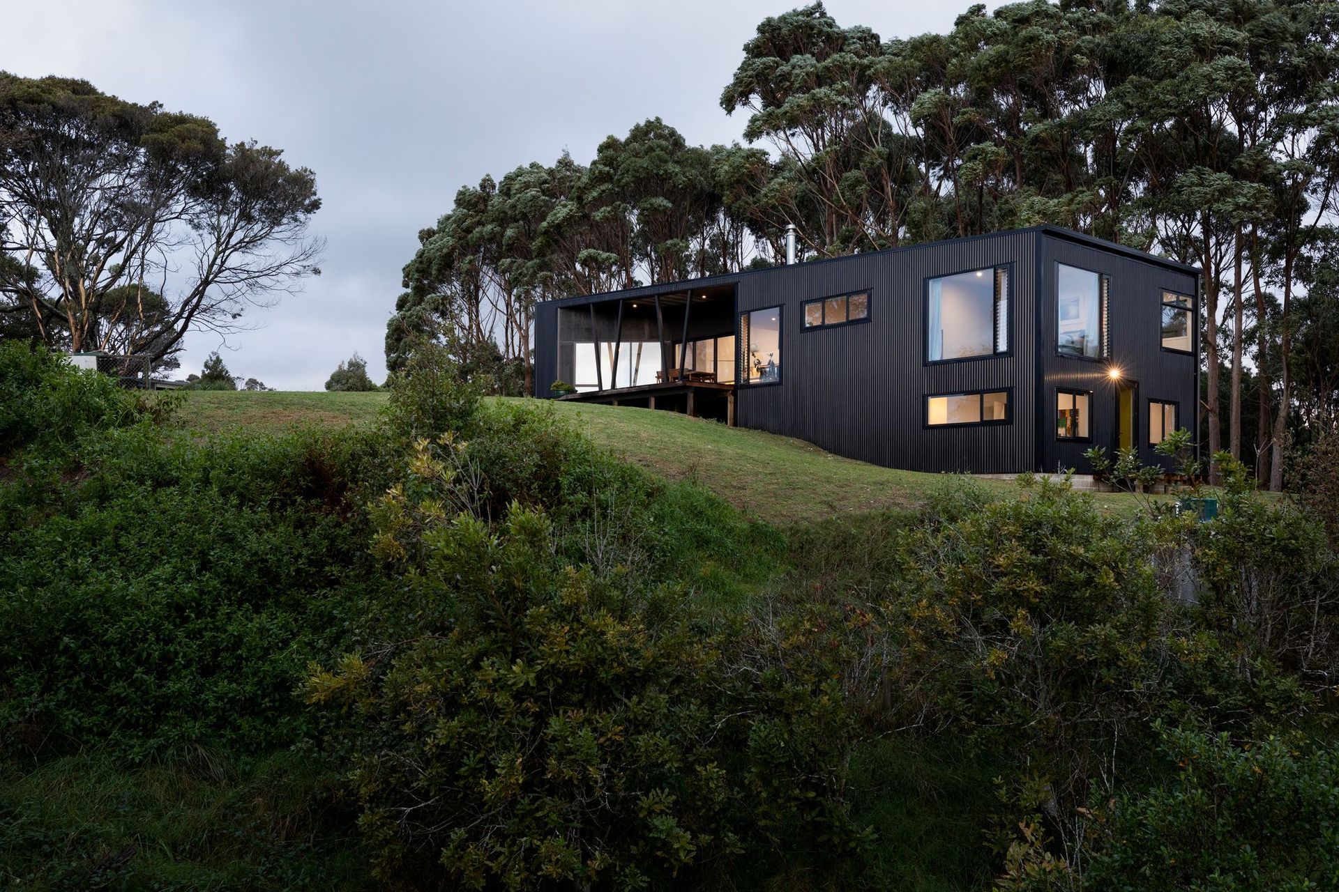 The plan takes advantage of the sloping site to accommodate two additional bedrooms downstairs, creating some separation between the main bedroom on the upper level and the children's bedrooms.