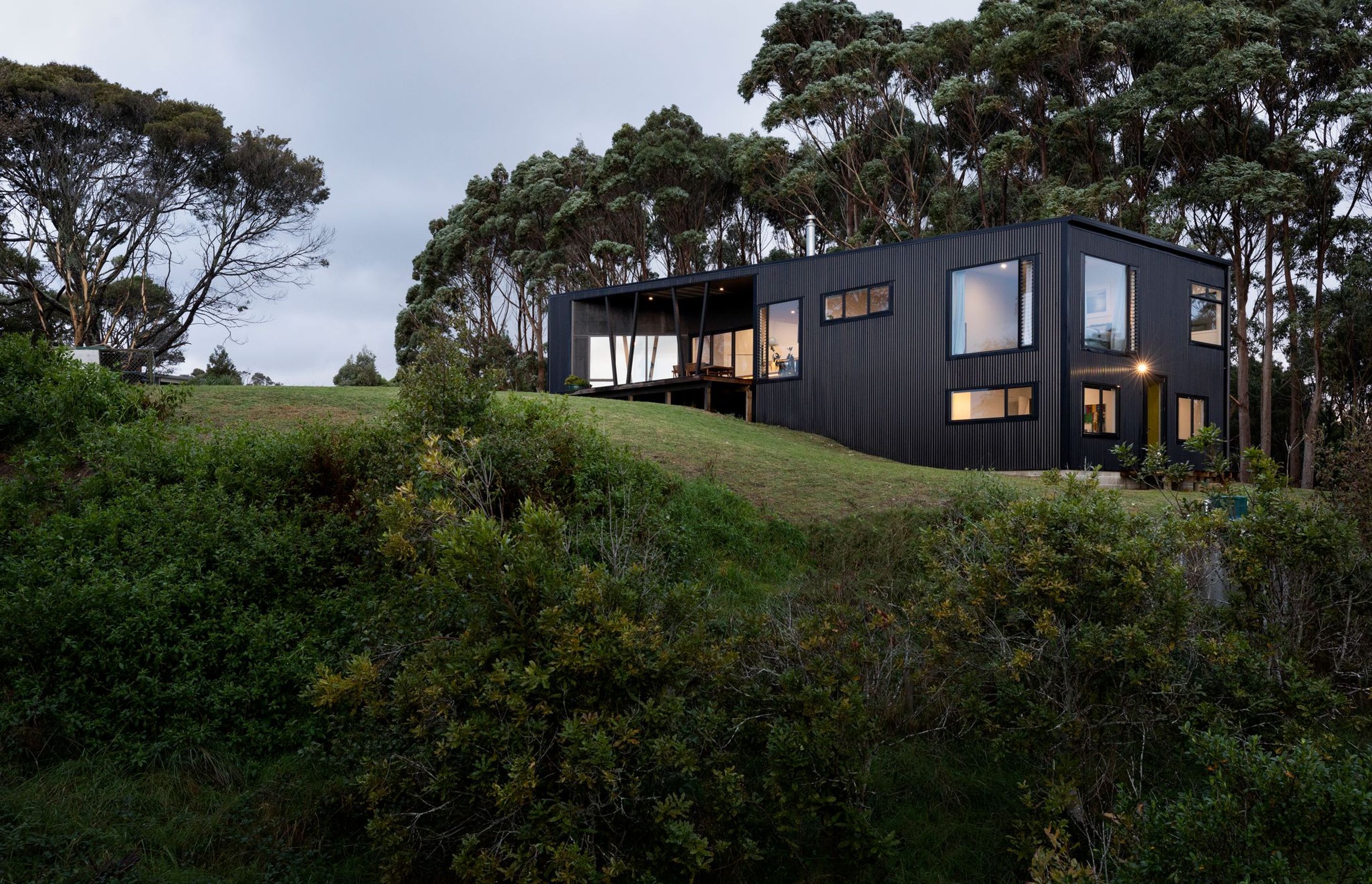 The plan takes advantage of the sloping site to accommodate two additional bedrooms downstairs, creating some separation between the main bedroom on the upper level and the children's bedrooms.