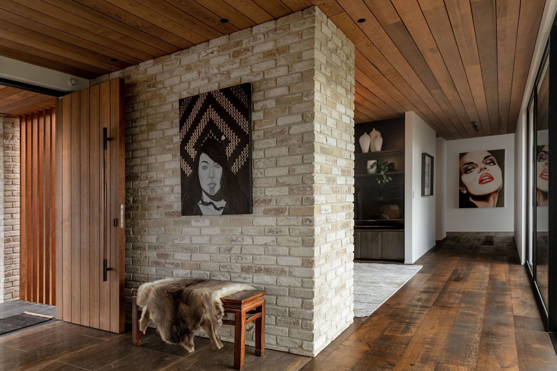 The entry is modest in volume and the hallway (with a library nook off it) leads to the guest wing and second living space.