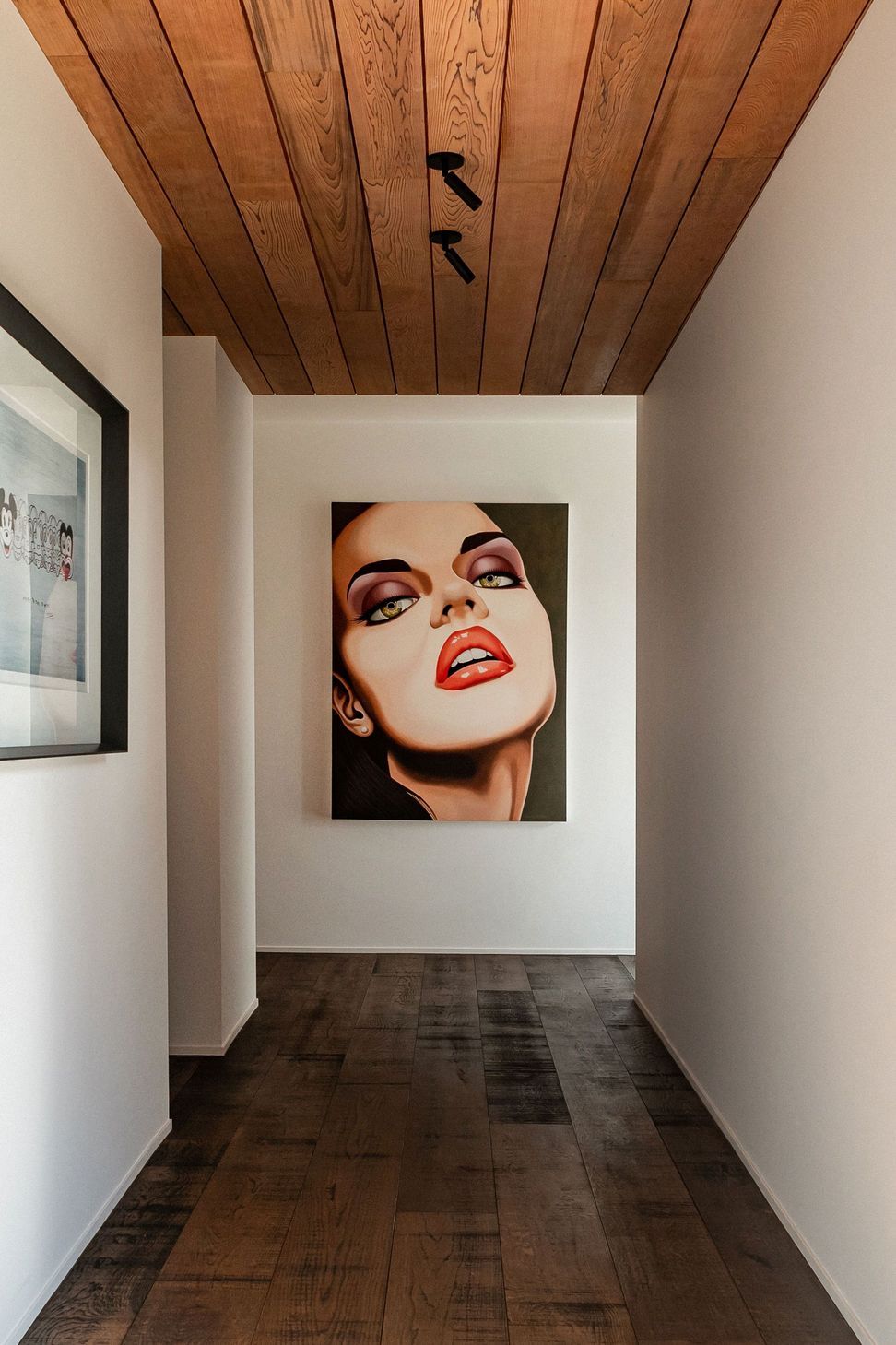 The hallway to the guest wing doubles as a gallery for the owners' art collection.