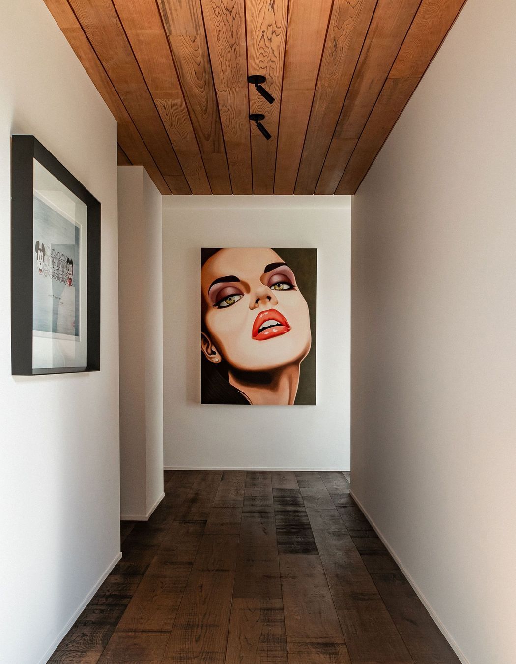 The hallway to the guest wing doubles as a gallery for the owners' art collection.