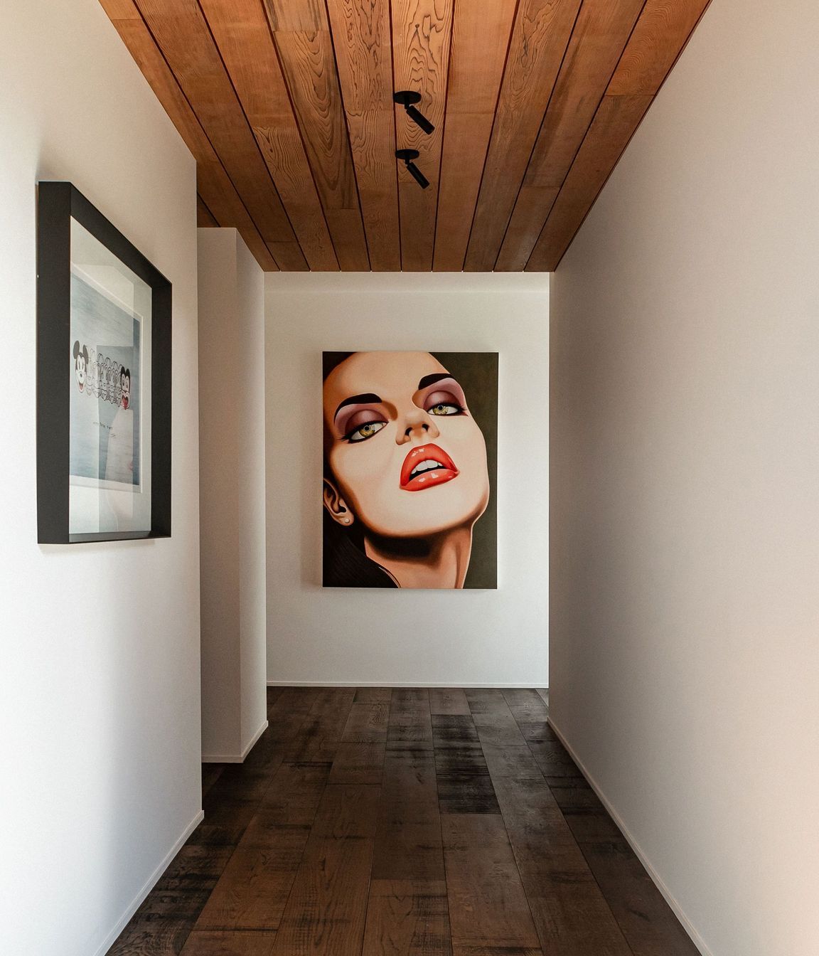 The hallway to the guest wing doubles as a gallery for the owners' art collection.