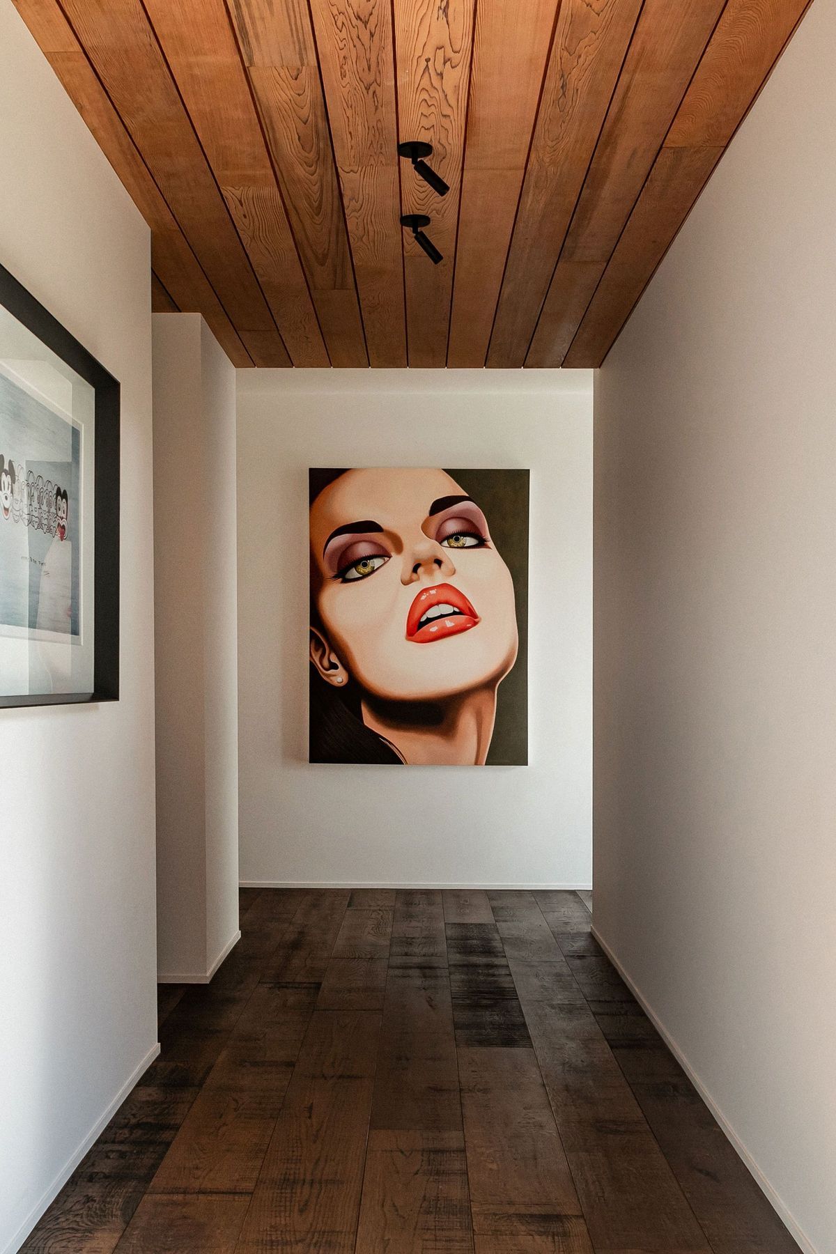 The hallway to the guest wing doubles as a gallery for the owners' art collection.
