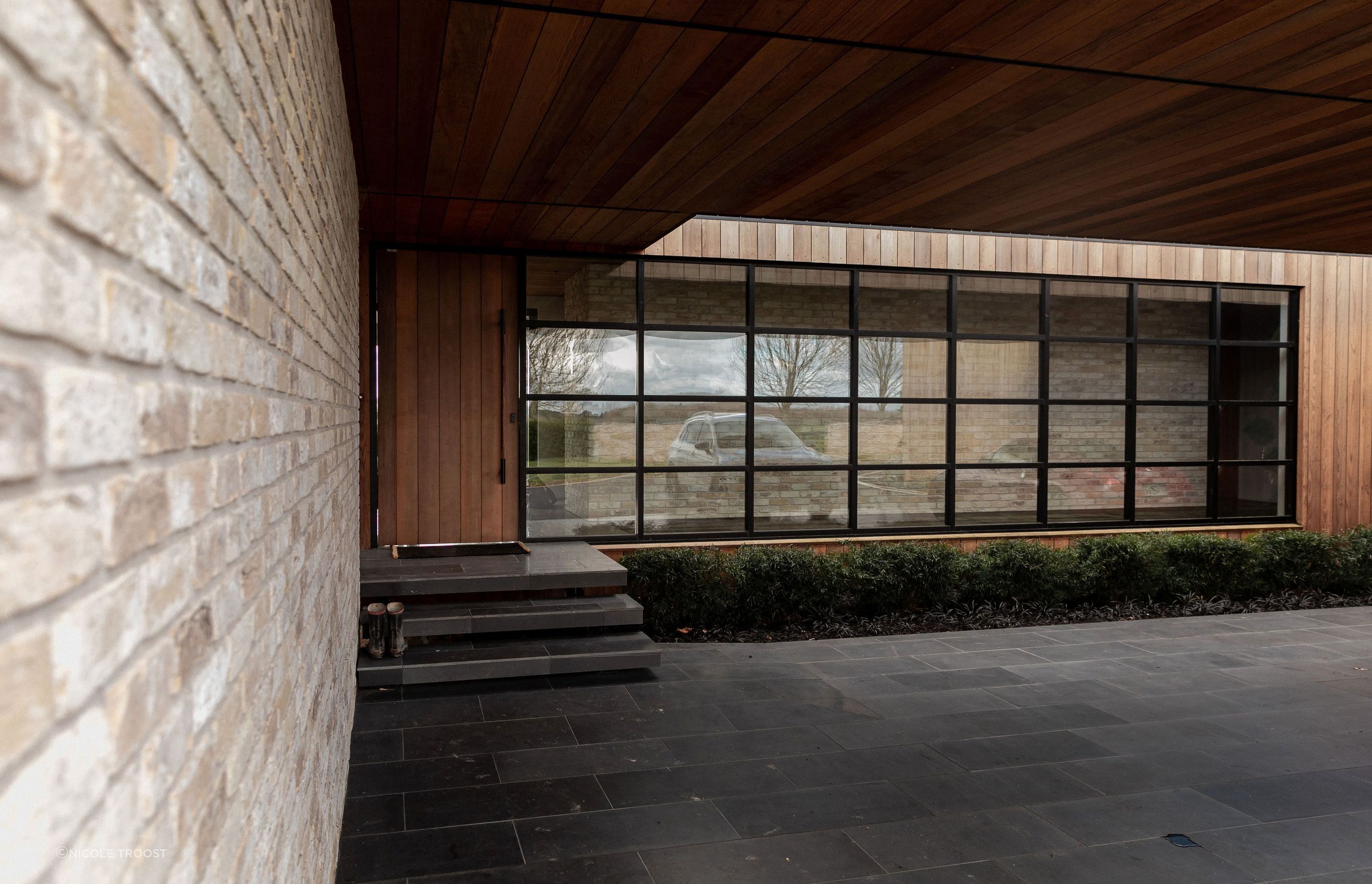 The entry space has mid-century feel with a farmhouse materiality.