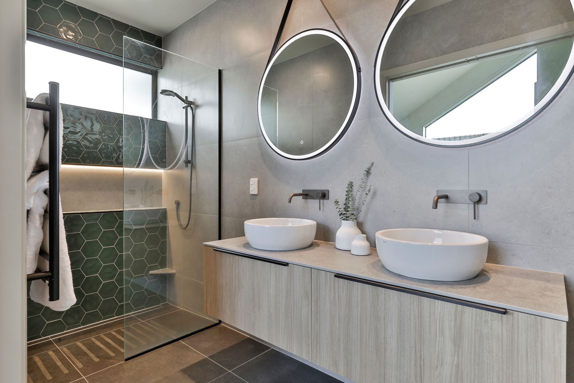 Design by Cube Dentro. The ensuite uses the same palette as the main bathroom - Cordoba Black 600x600mm on the floor with Cordoba Pearl 600x600mm on the wall. Hexa Green Echo Gloss 173x150mm creates a glossy deep green feature wall in the shower.