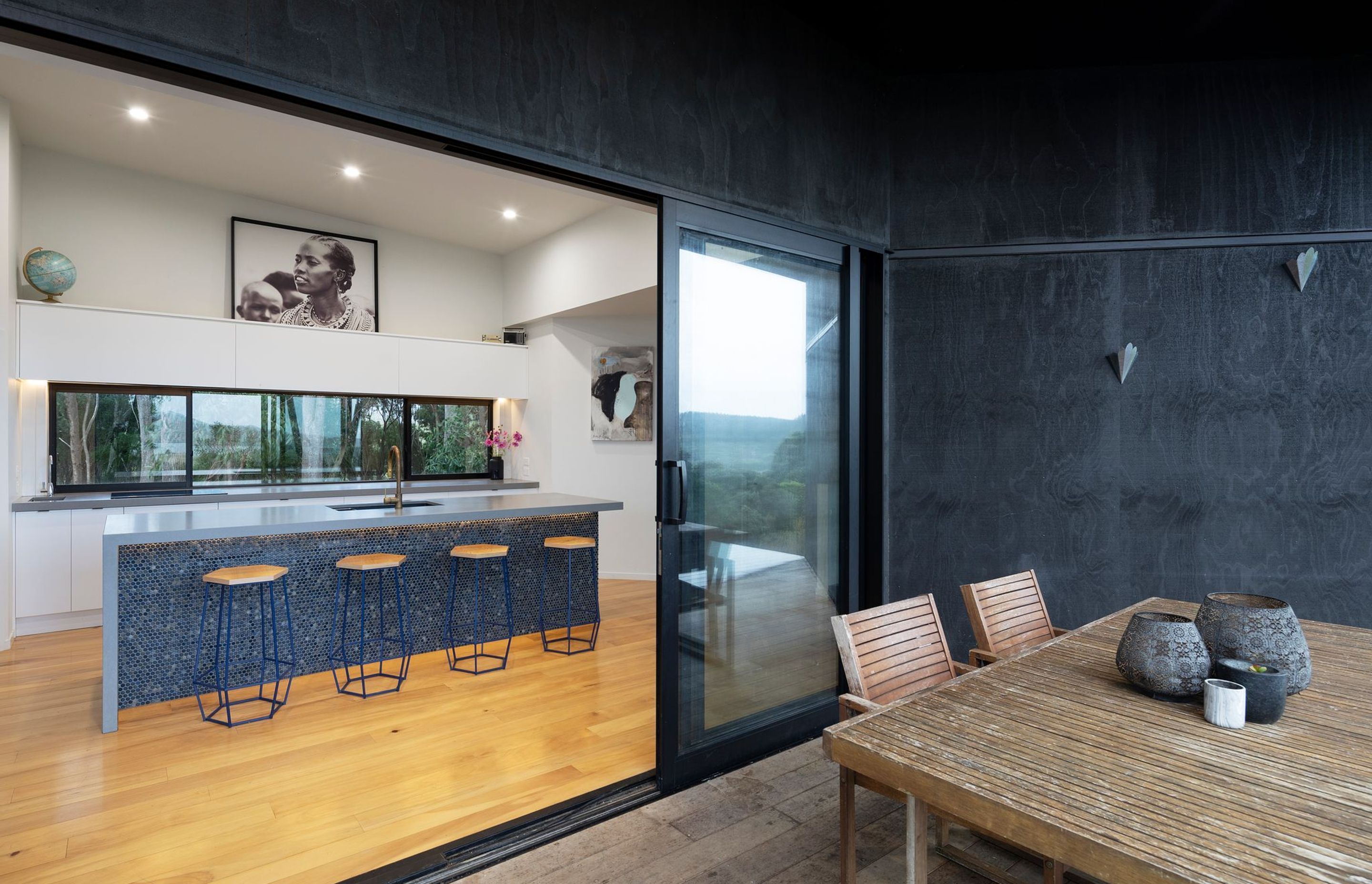 Stained ply lends a softer aesthetic to the covered courtyard space, offsetting the metal cladding the covers the remainder of the house.